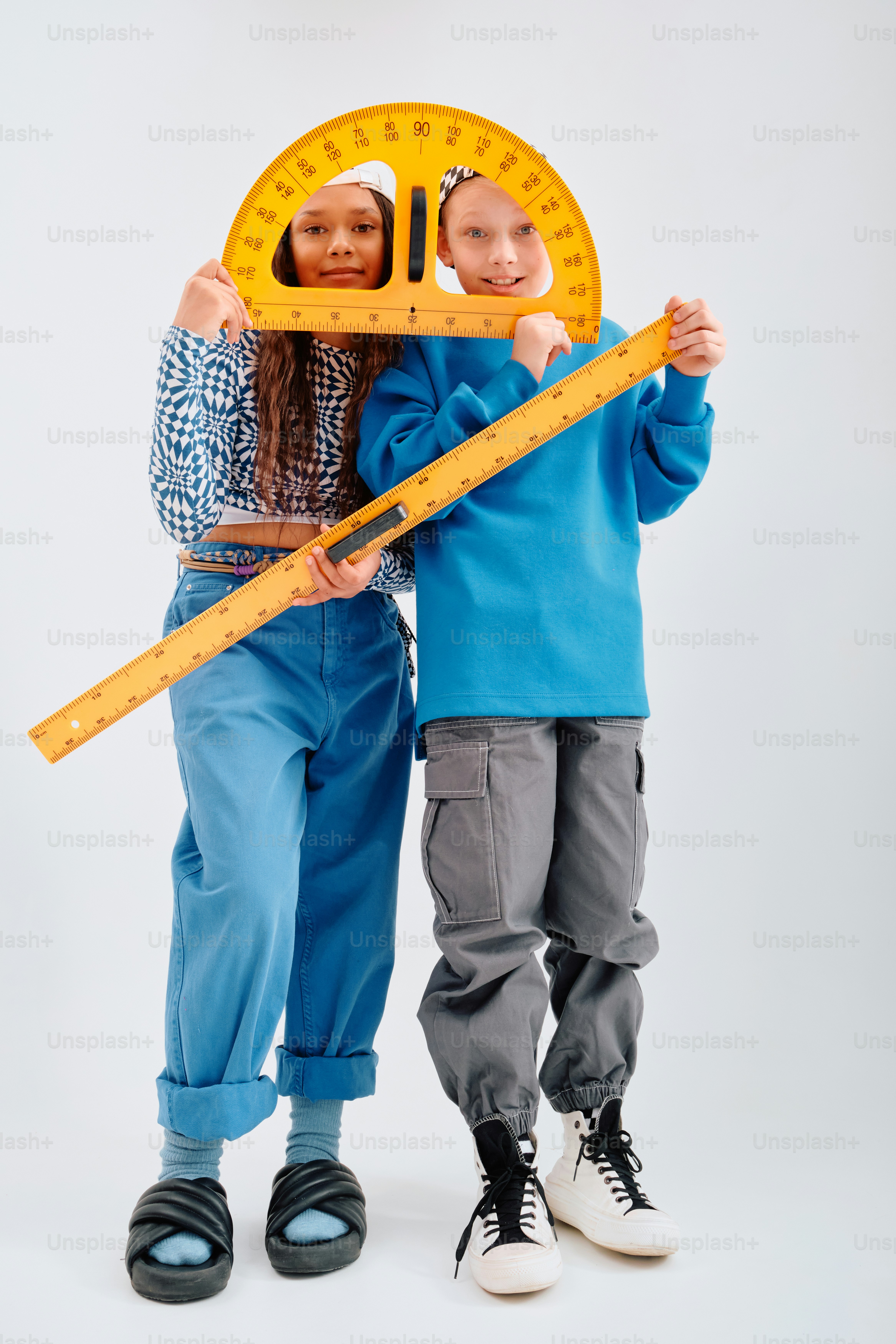 Two children holding large math rulers and protractor photo – Education ...