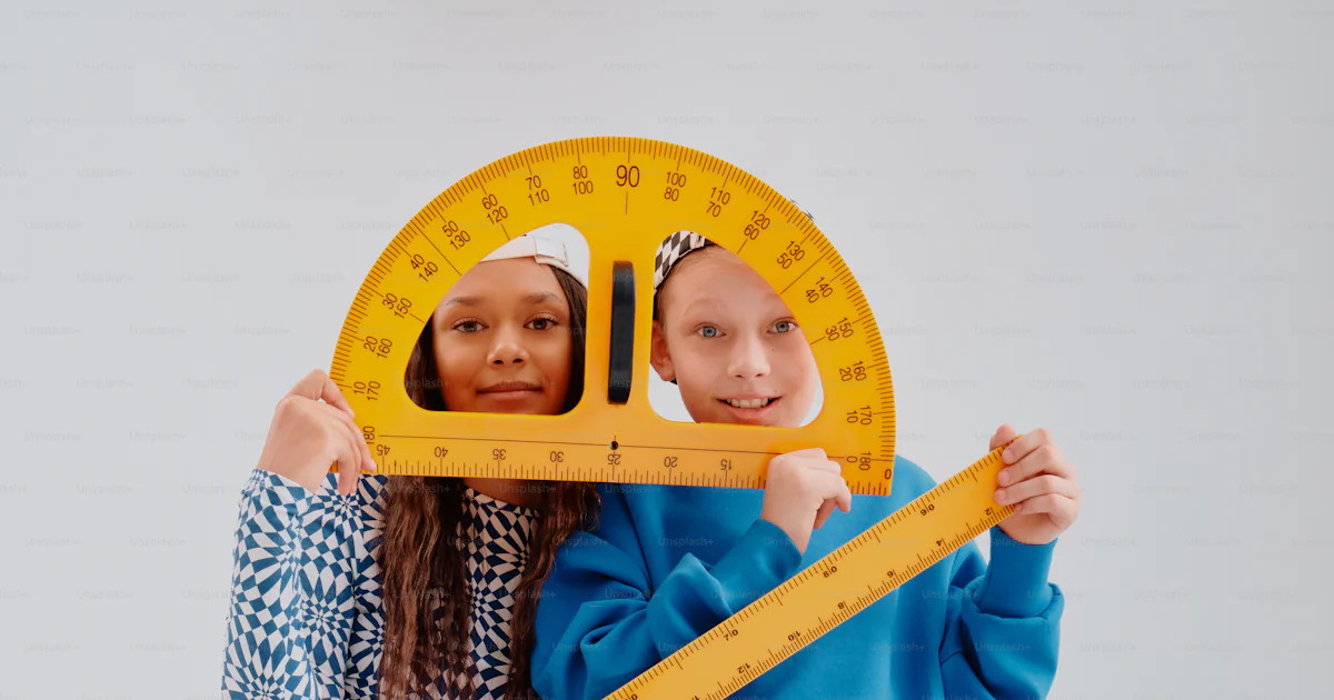 Kids Using A Ruler Two children holding large math rulers and protractor photo – Education ...