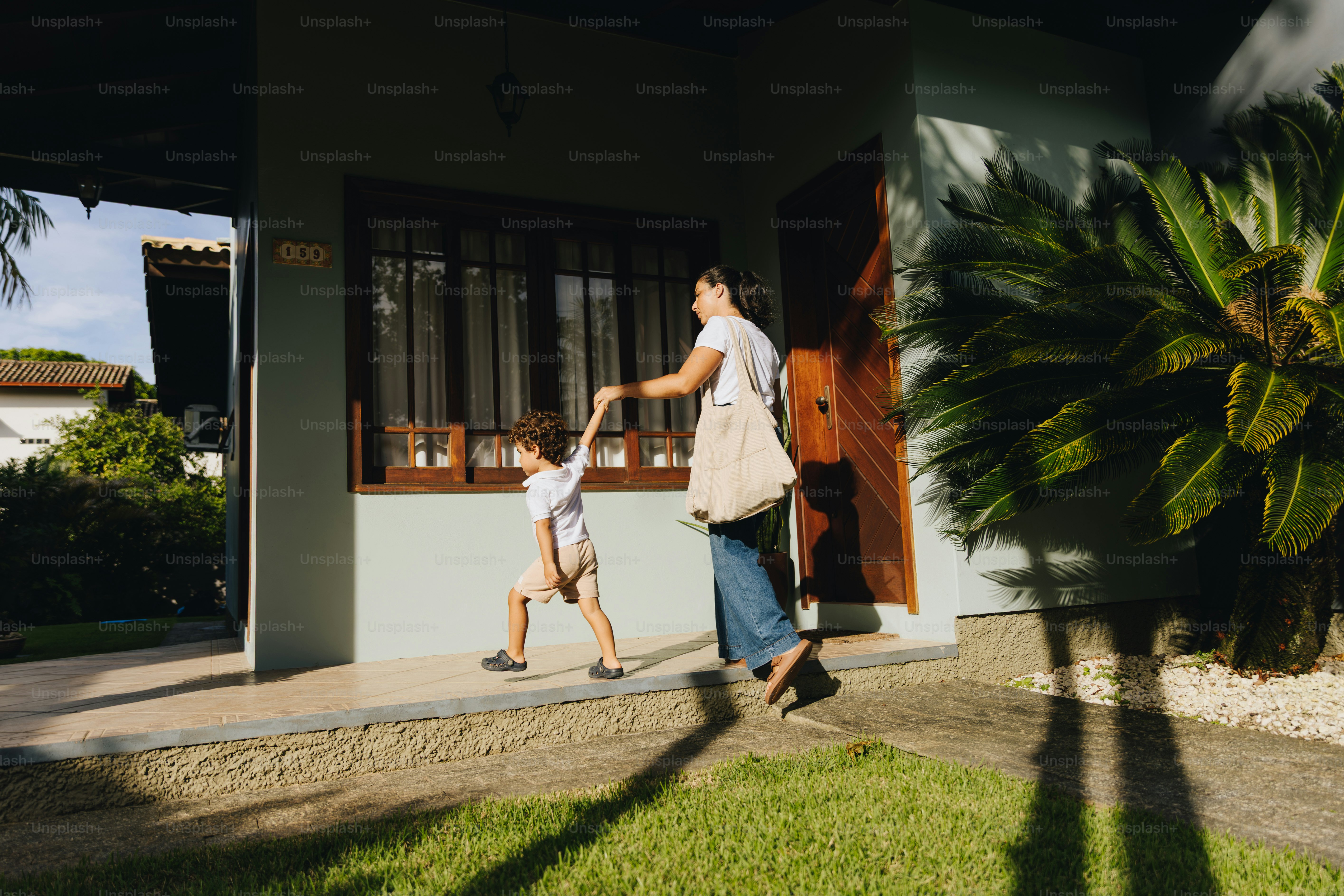 Mother and child walking away from house