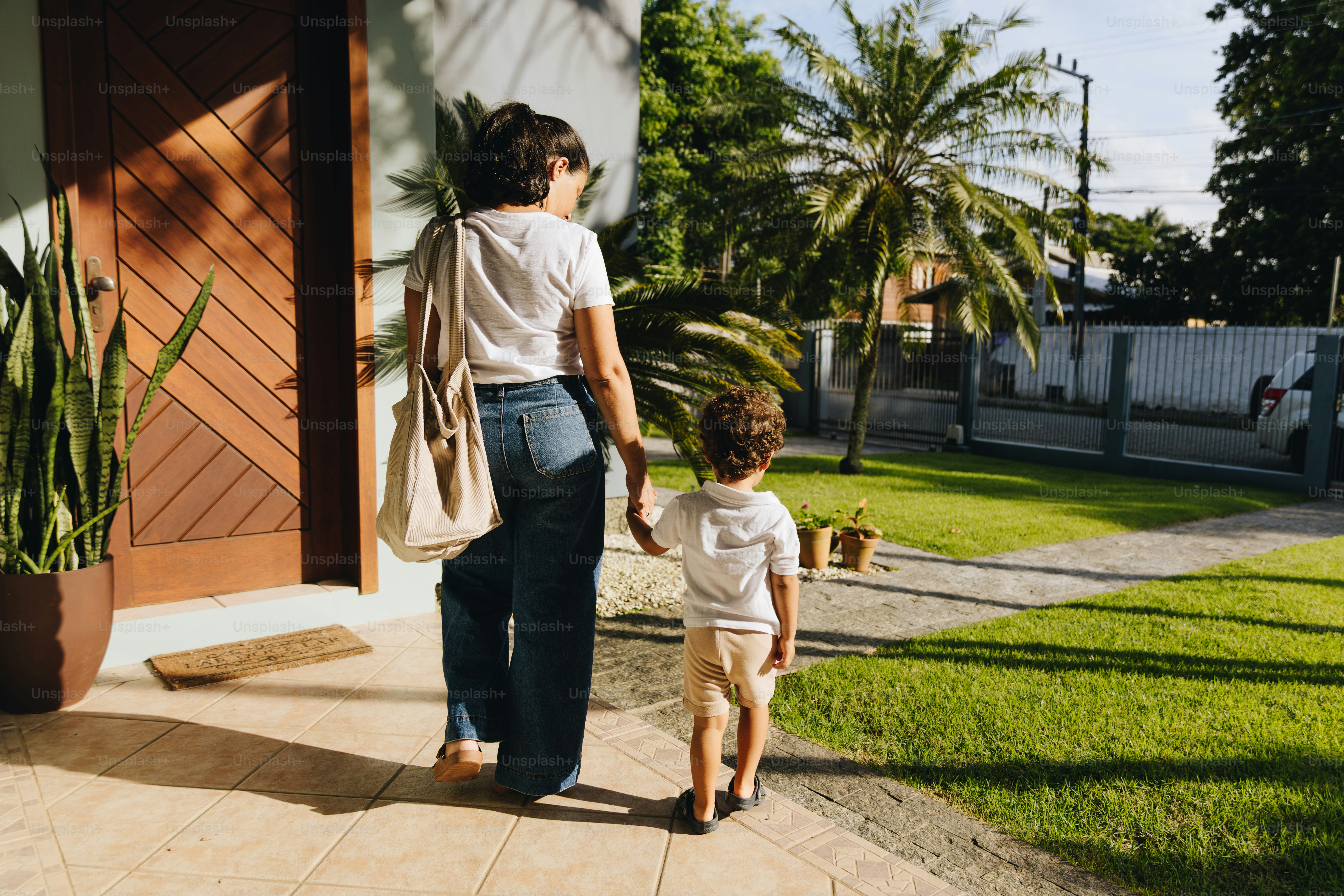 Woman and child walk away from house