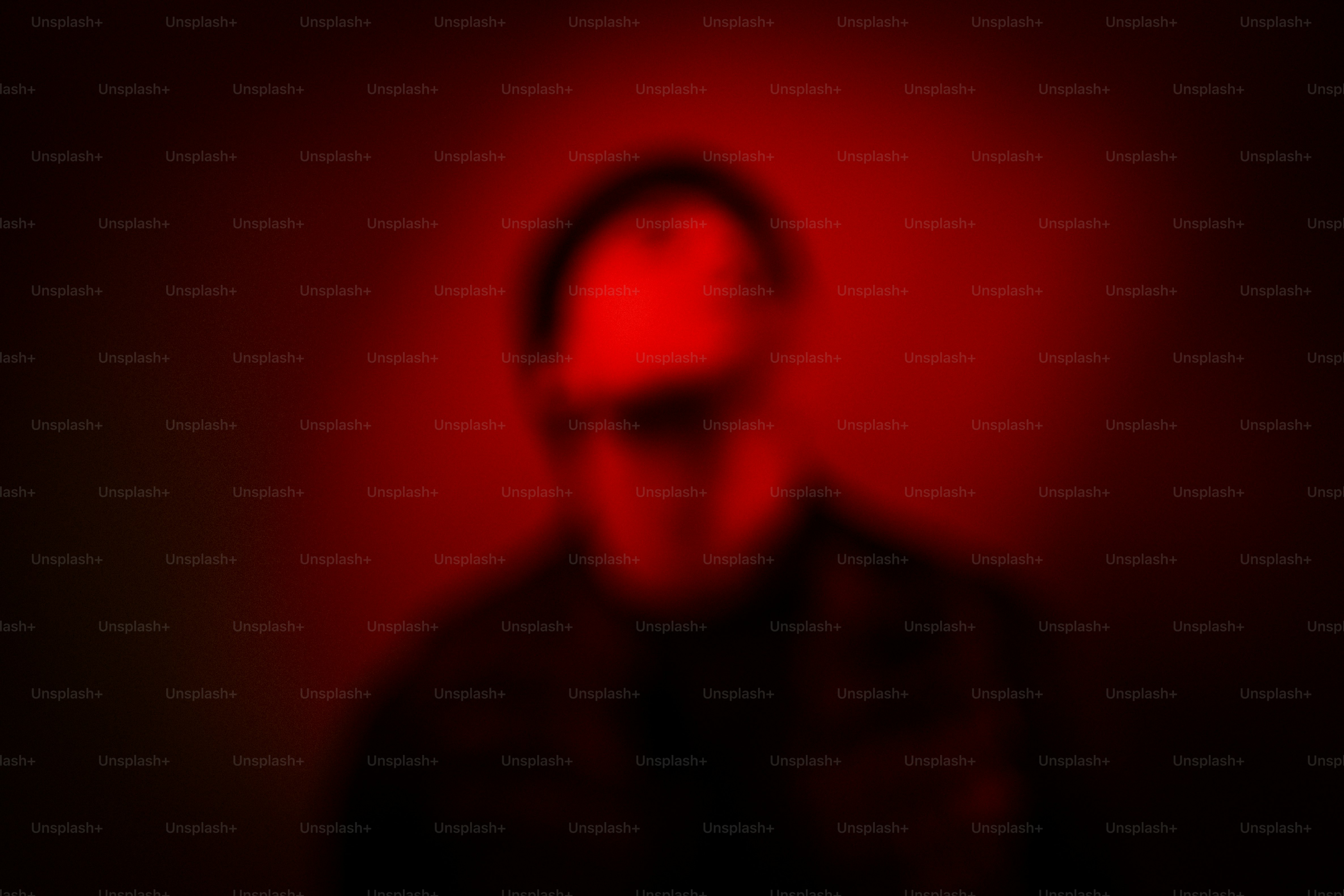 Man in sunglasses with red lighting.
