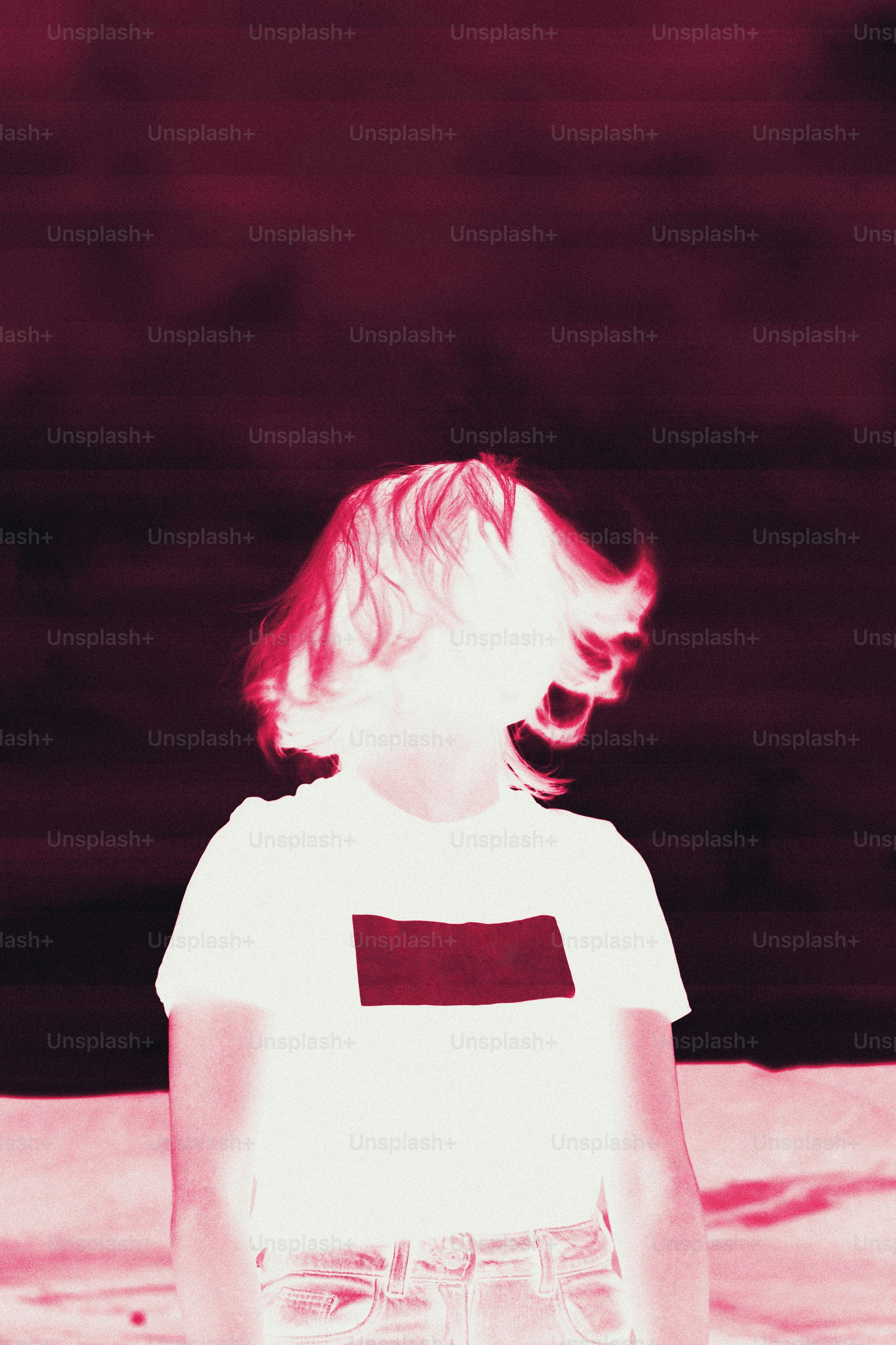 A person with short, light-colored hair in a white shirt.