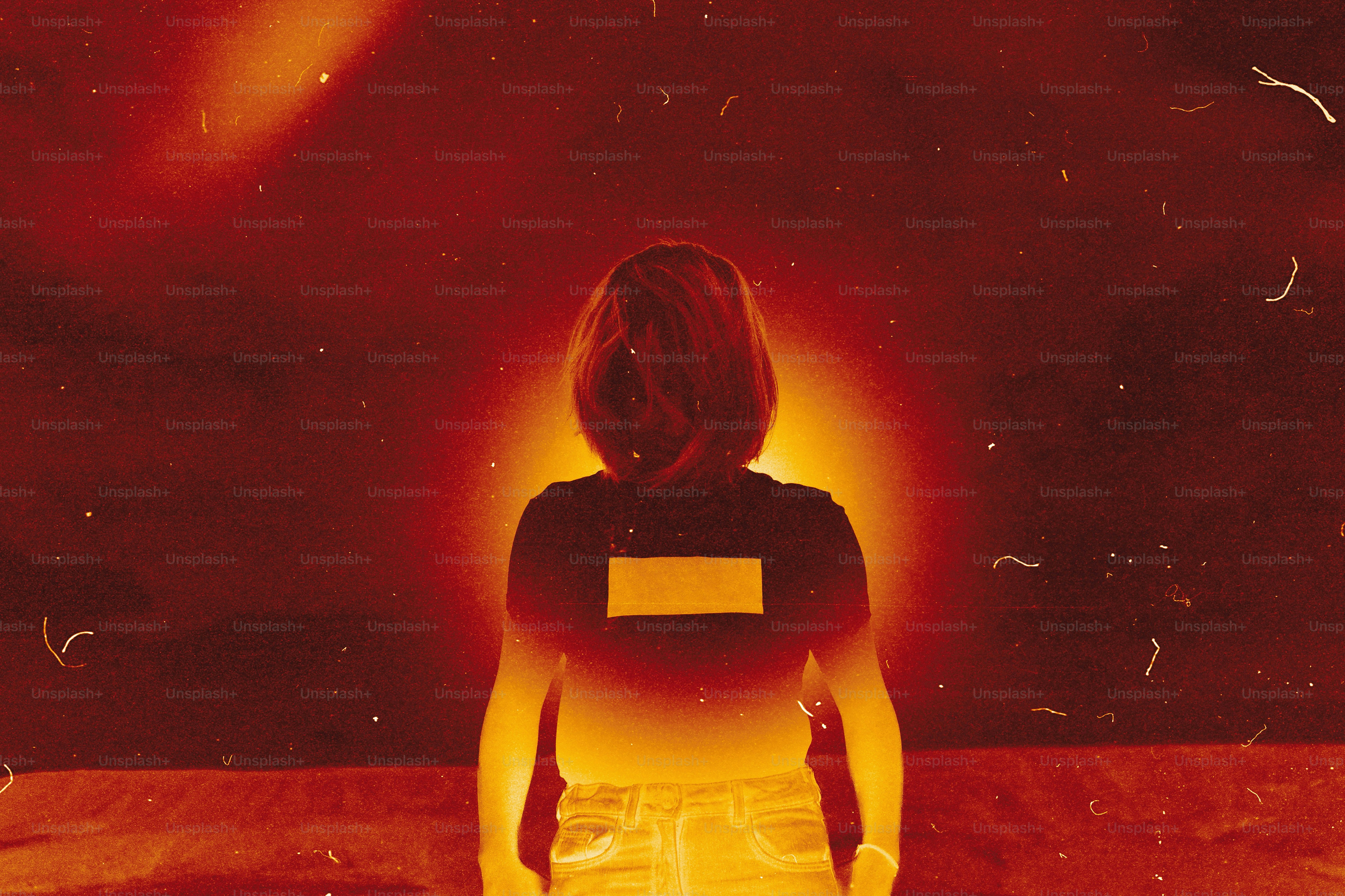 Woman with glowing aura against dark background