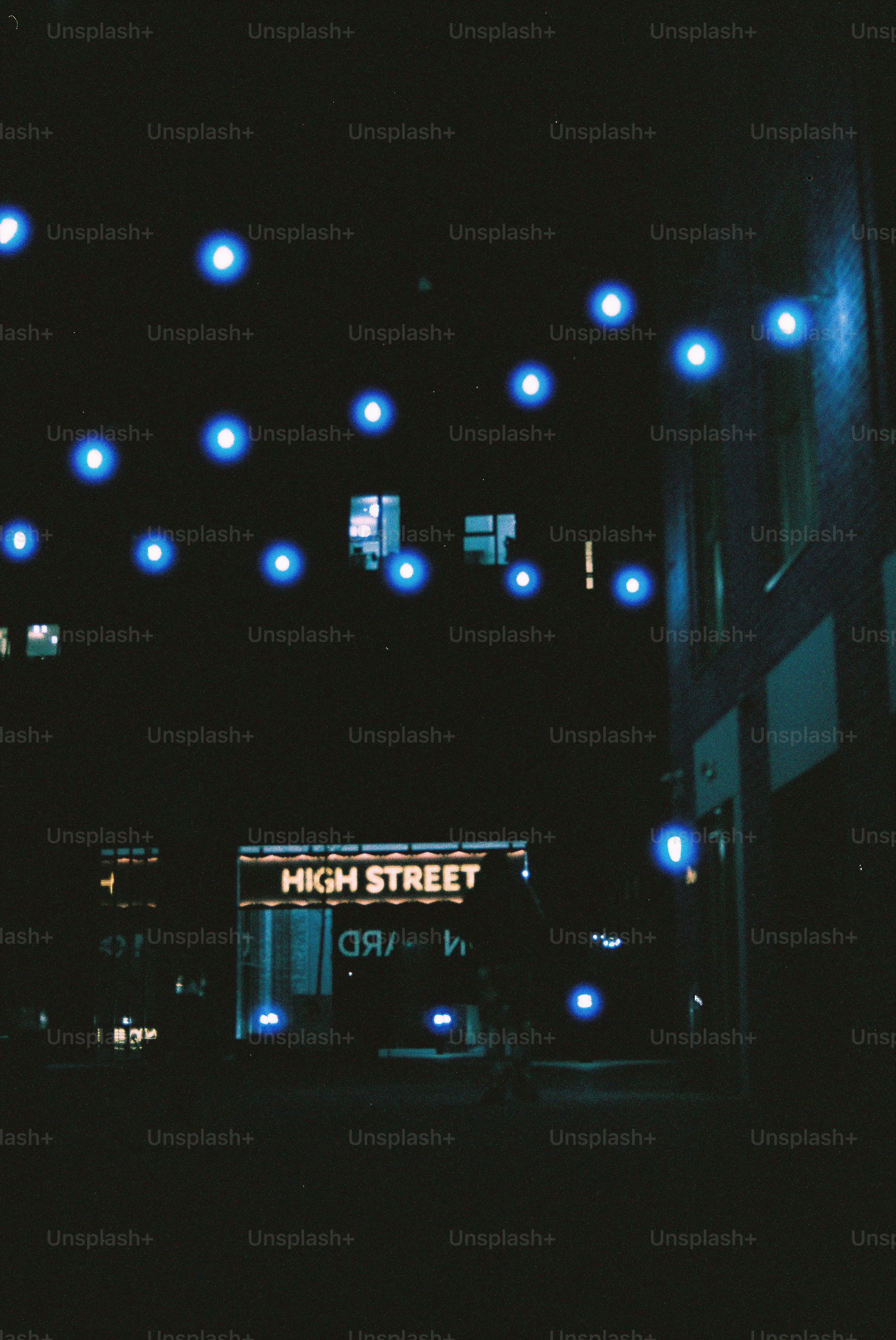 Blue lights strung across a dark alley at night