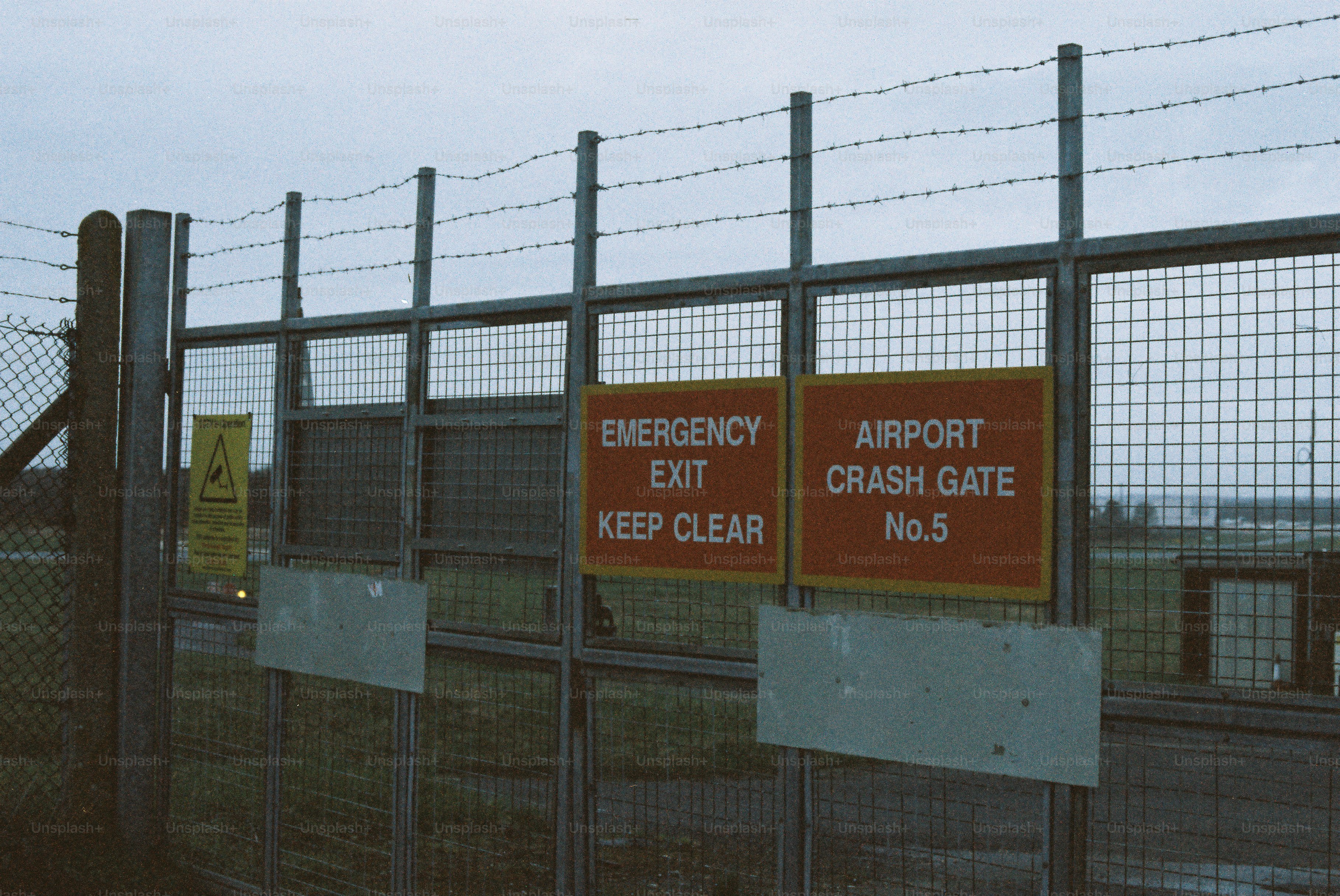 Airport crash gate with emergency exit sign photo – Film Image on 