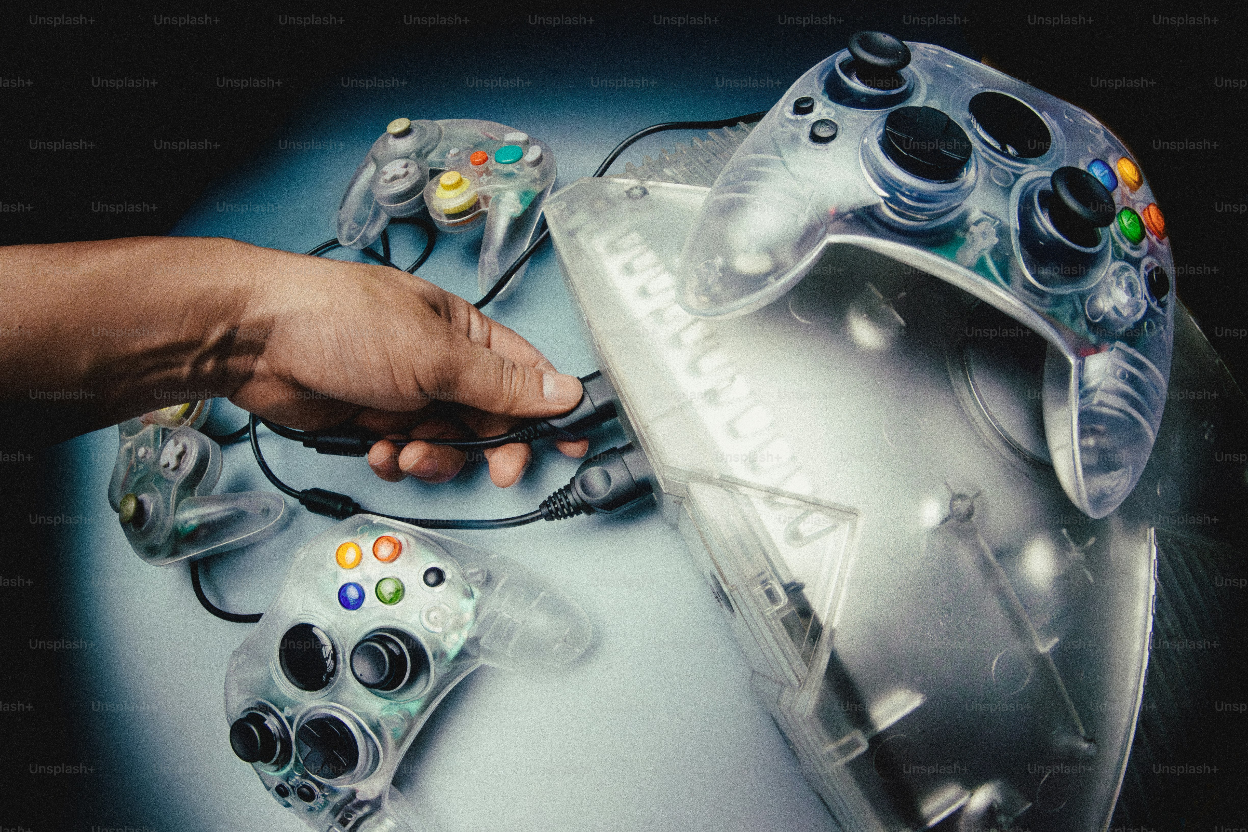 Clear video game controllers and discs on a surface photo – Technology ...