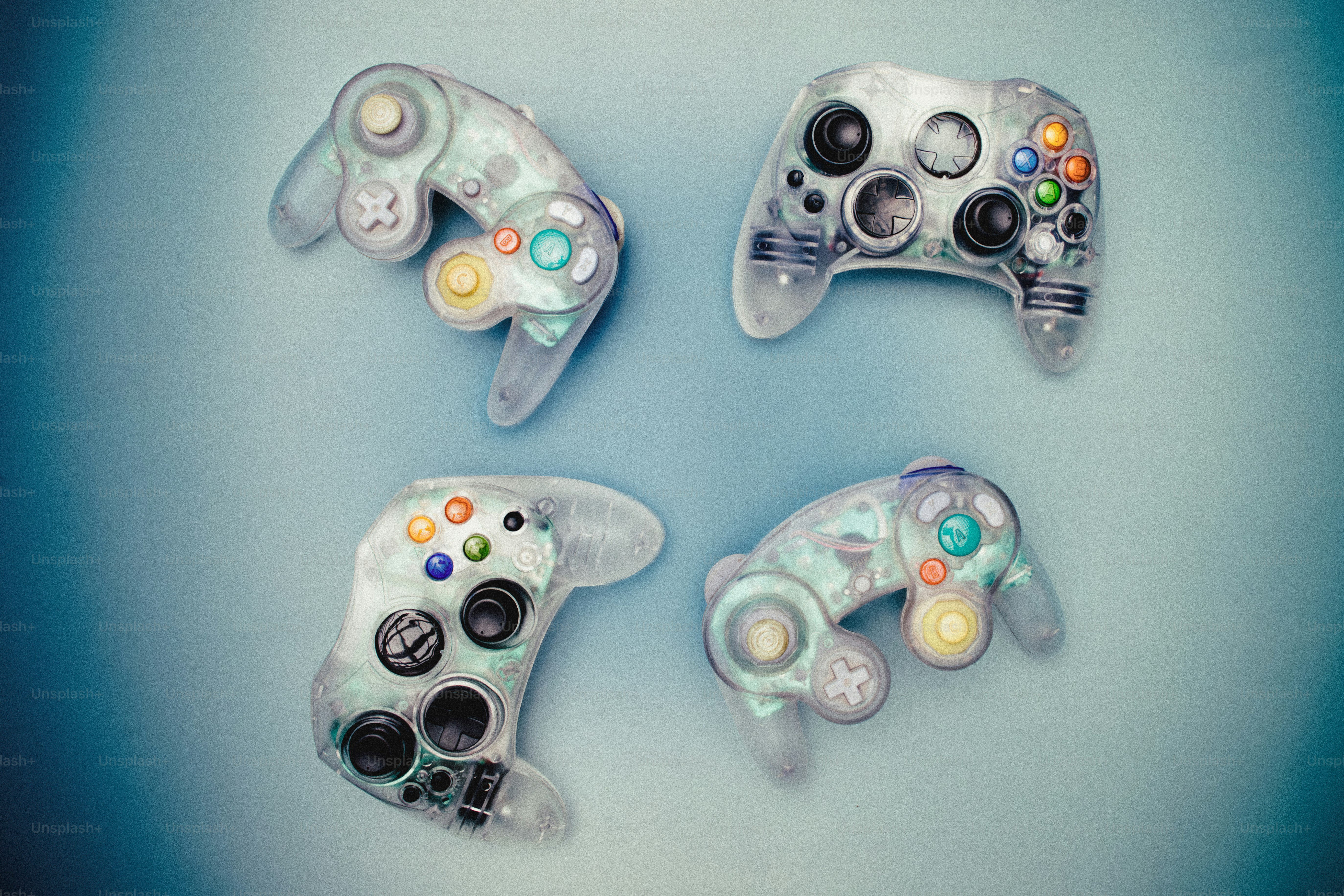 Clear video game controllers and discs on a surface photo – Technology ...