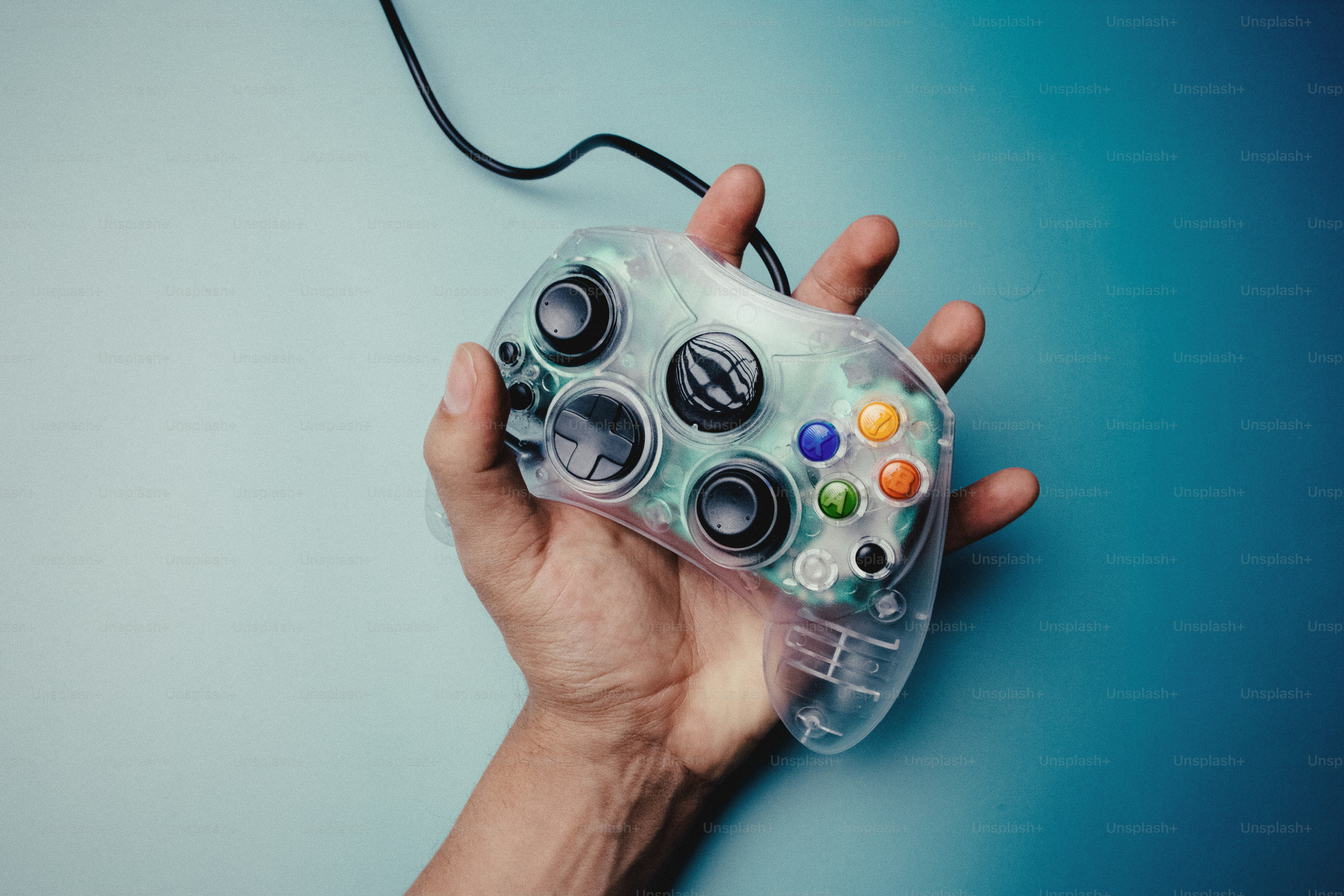 Hand holding a clear video game controller photo – Gaming Image on Unsplash