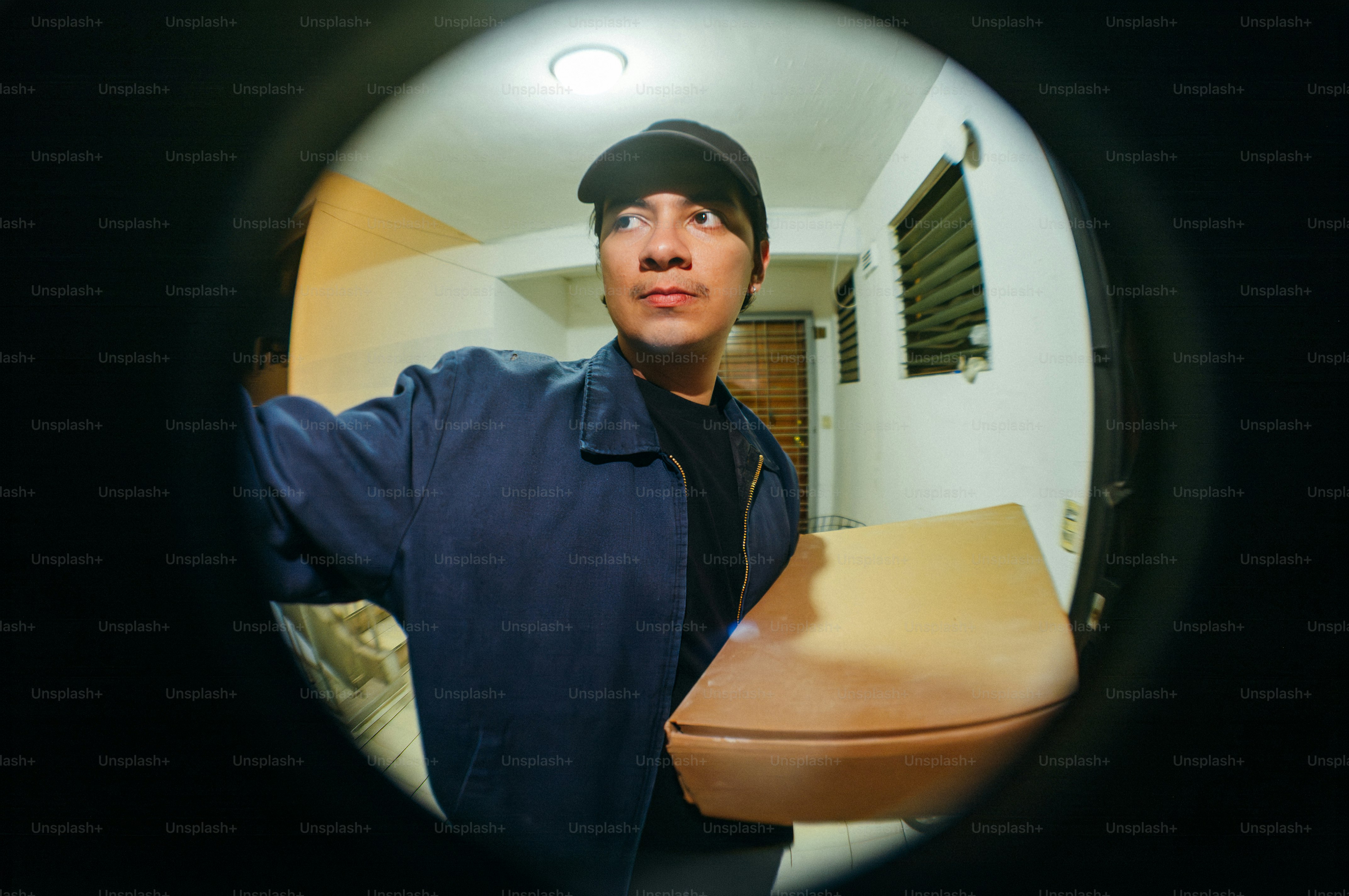 Delivery person holding a package at the door