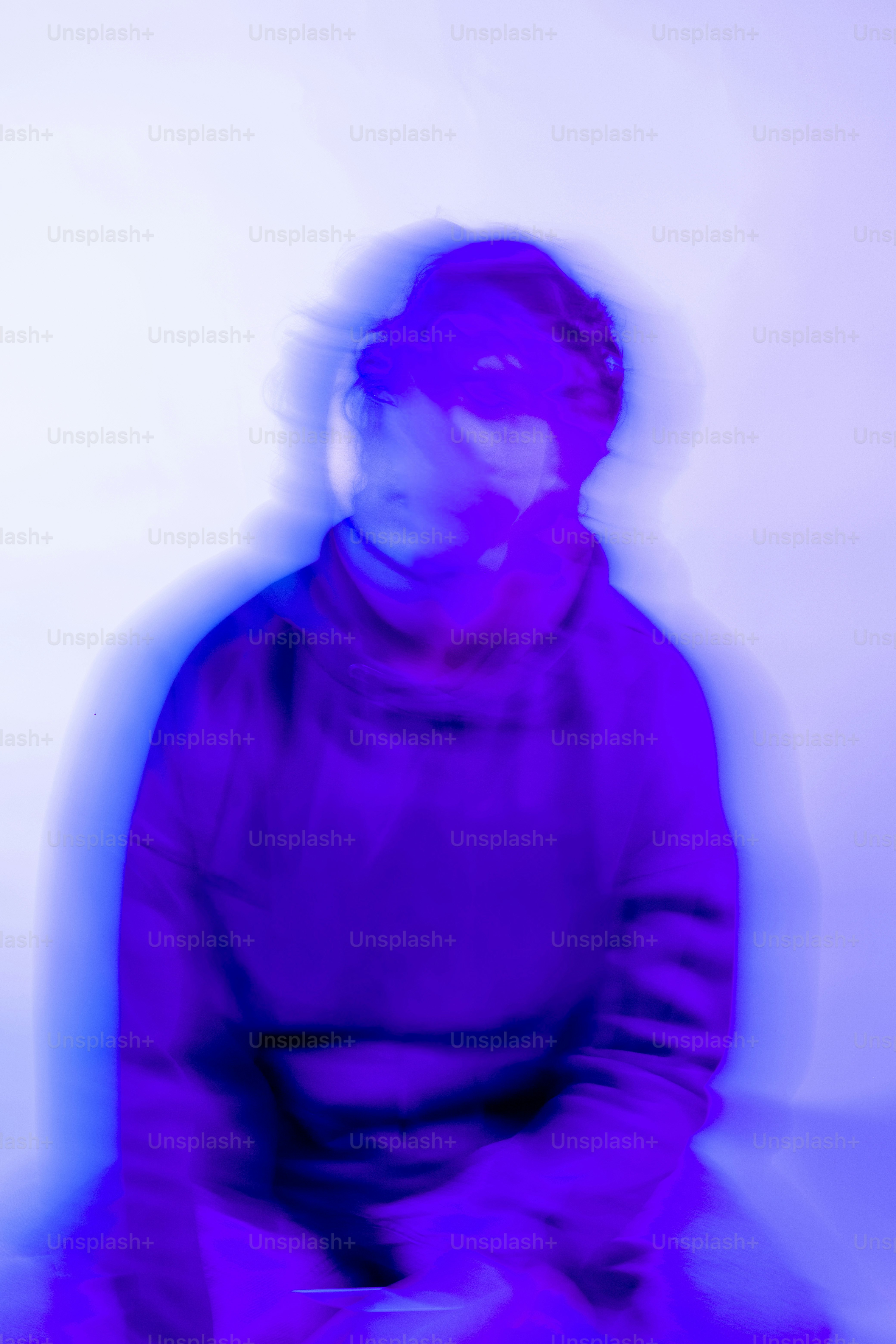 Blurry figure in purple and blue tones
