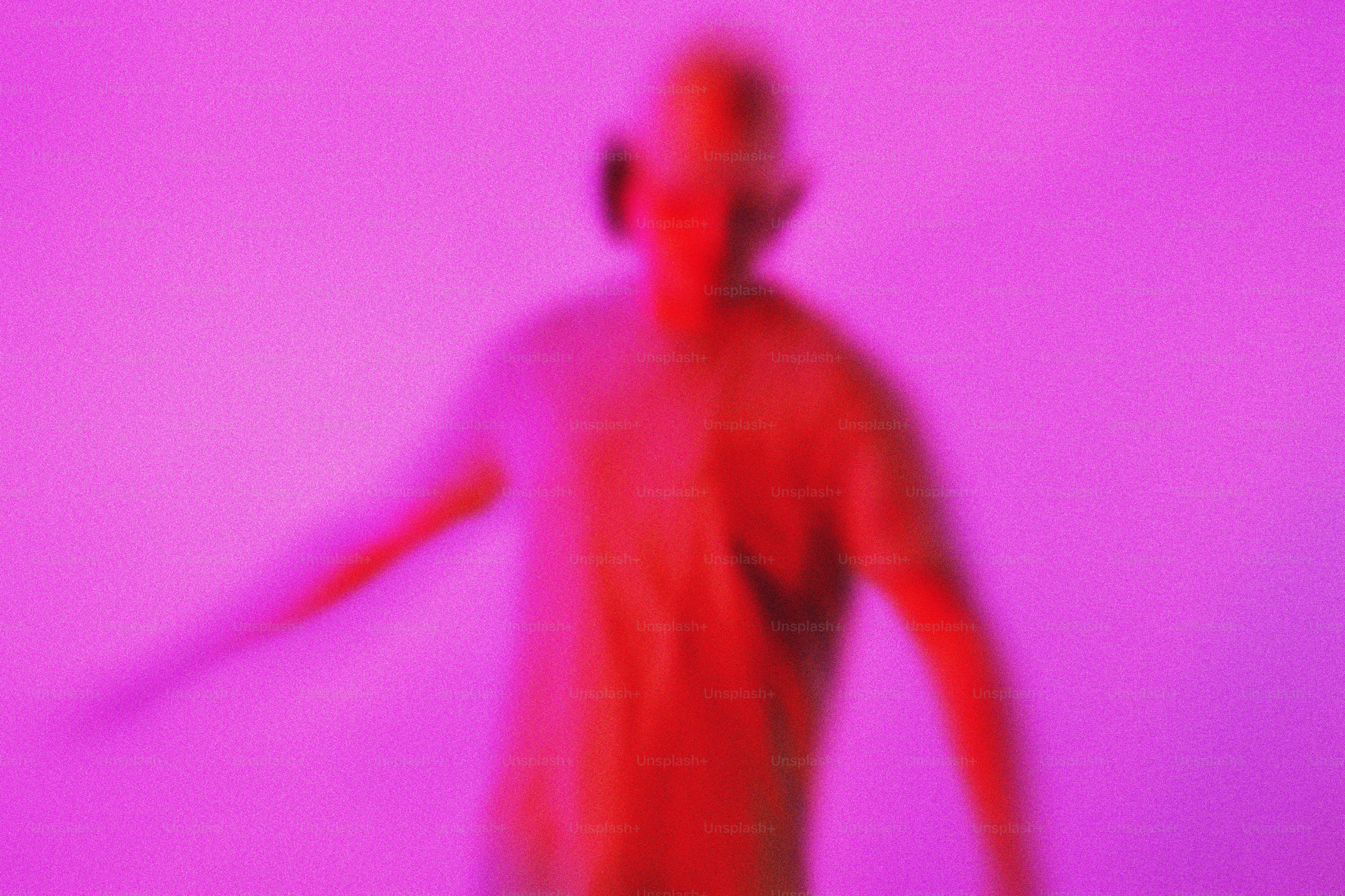 A blurred figure in neon pink and red light