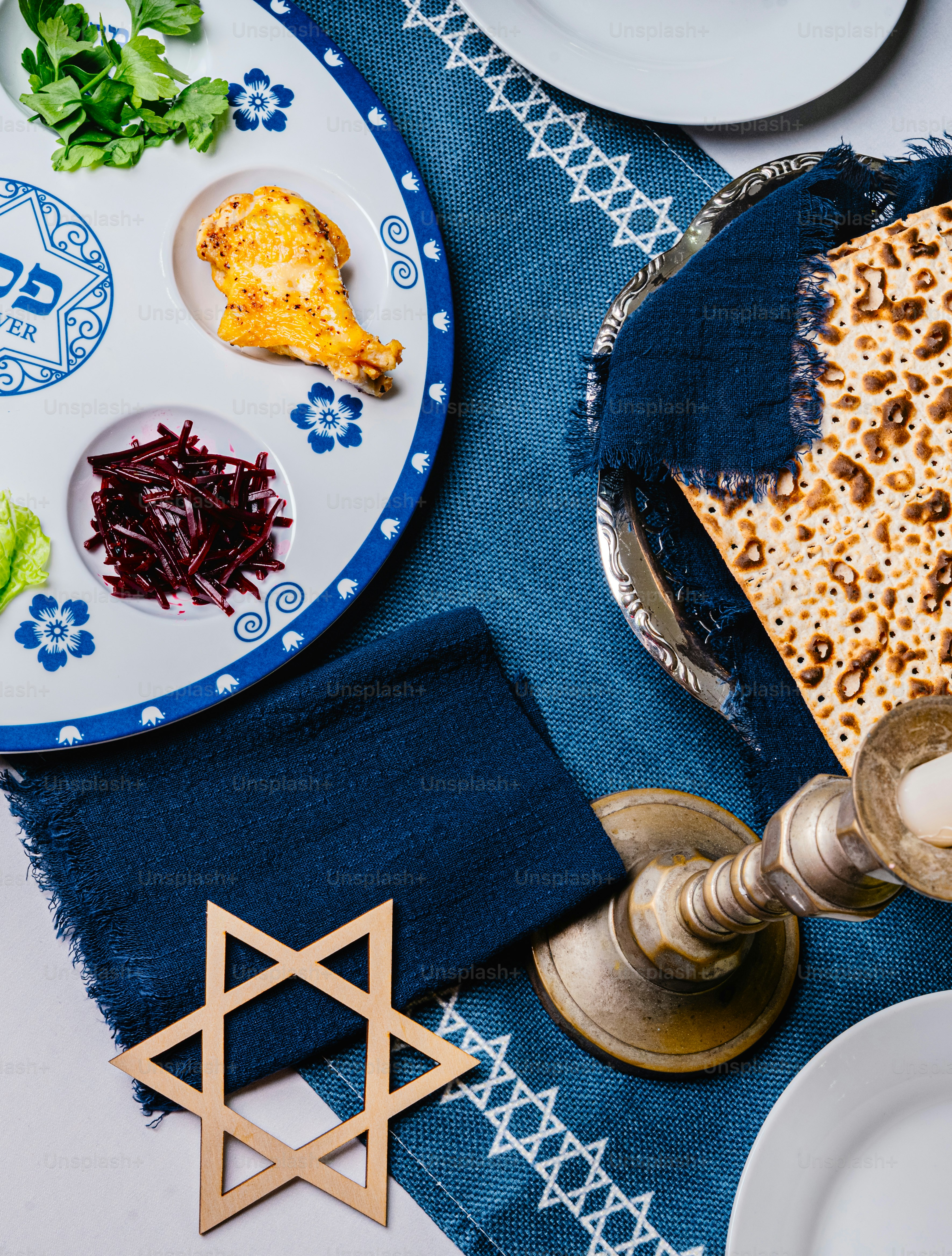 Seder plate with matzah and candle holder on table photo – Passover ...