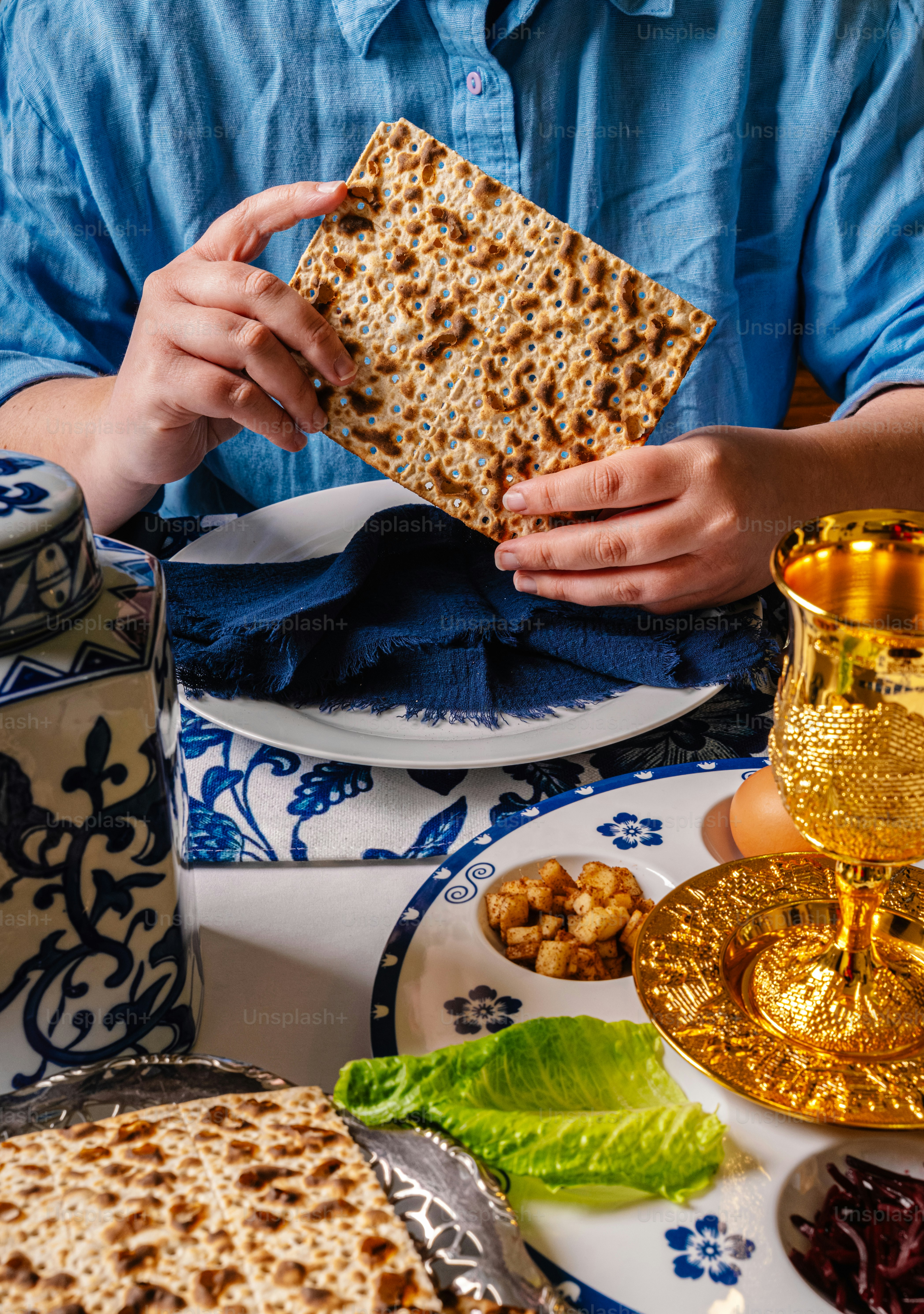 Person holding matzah at a seder table photo – Spiritual Image on Unsplash