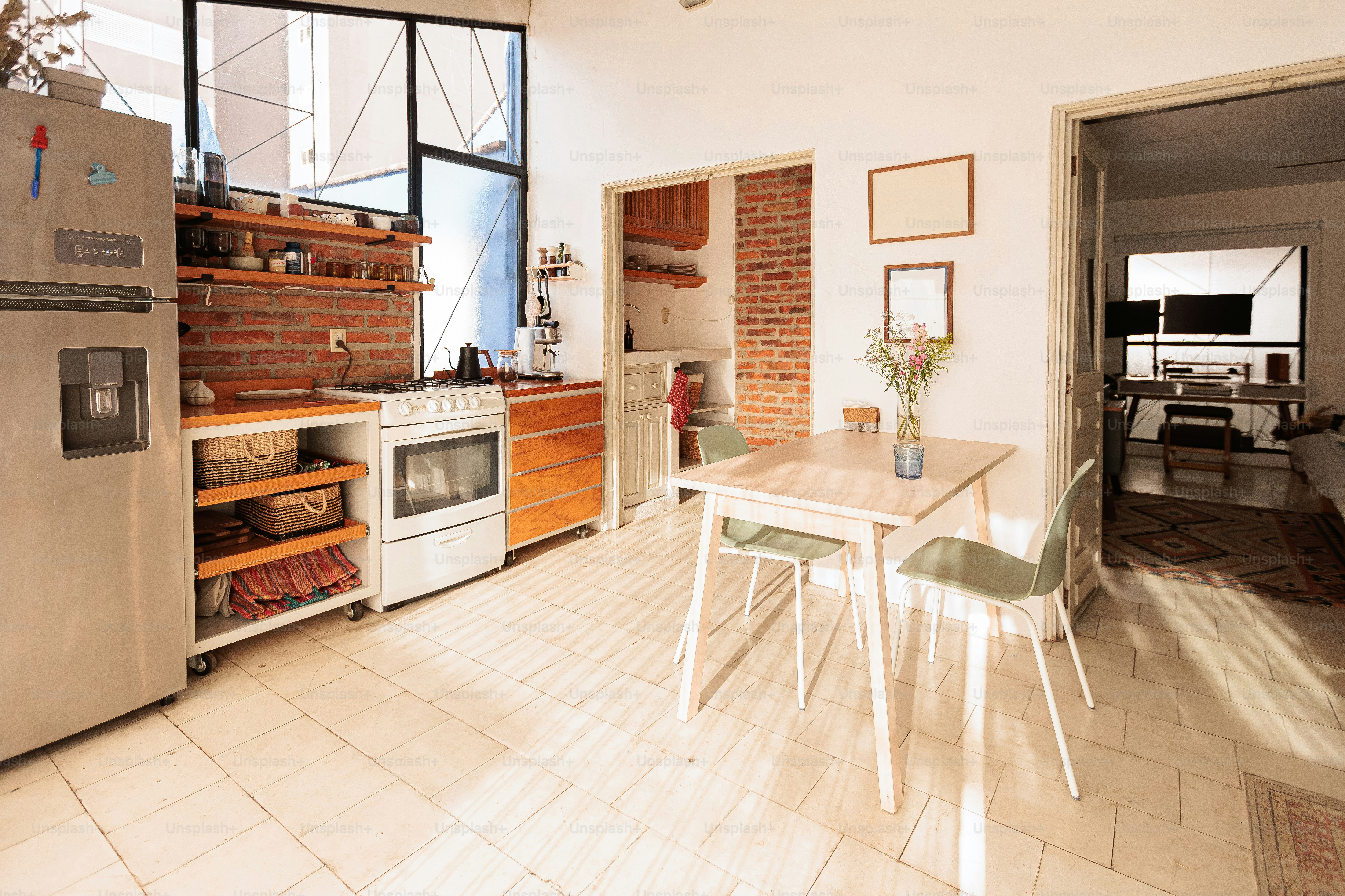 A bright kitchen with a dining table and chairs.