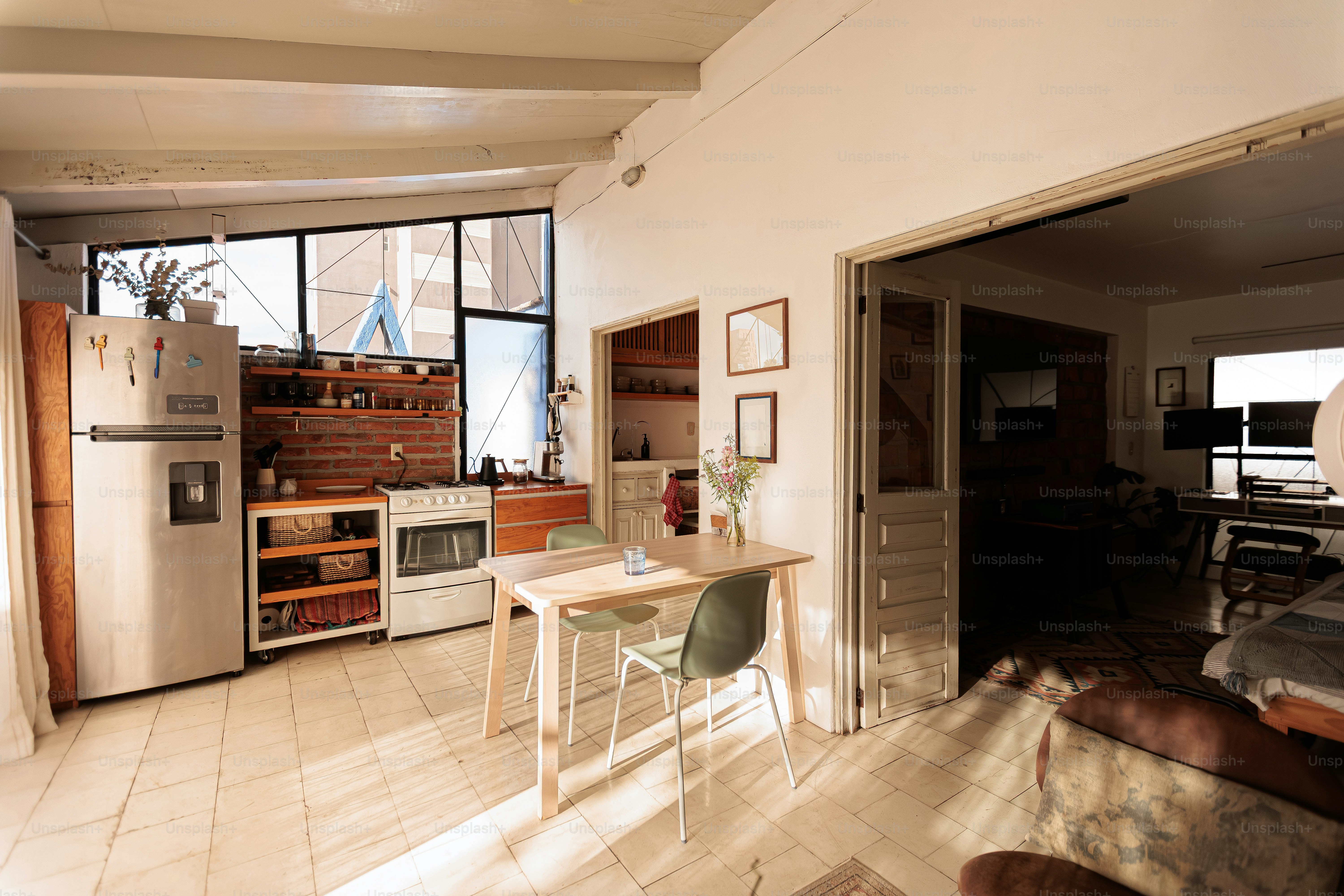 Bright kitchen with dining table and open doorway