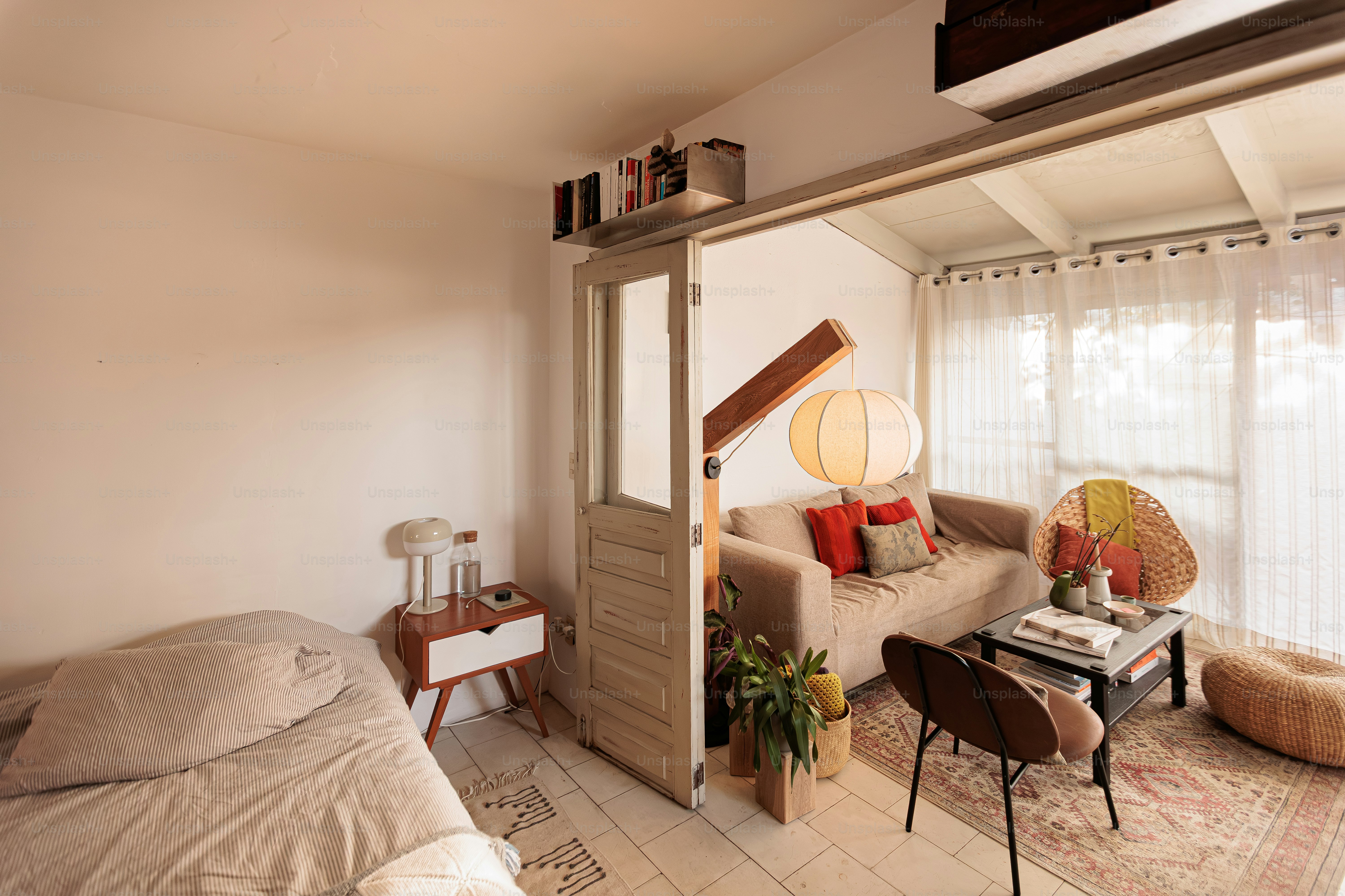 Cozy studio apartment with bed and living area.