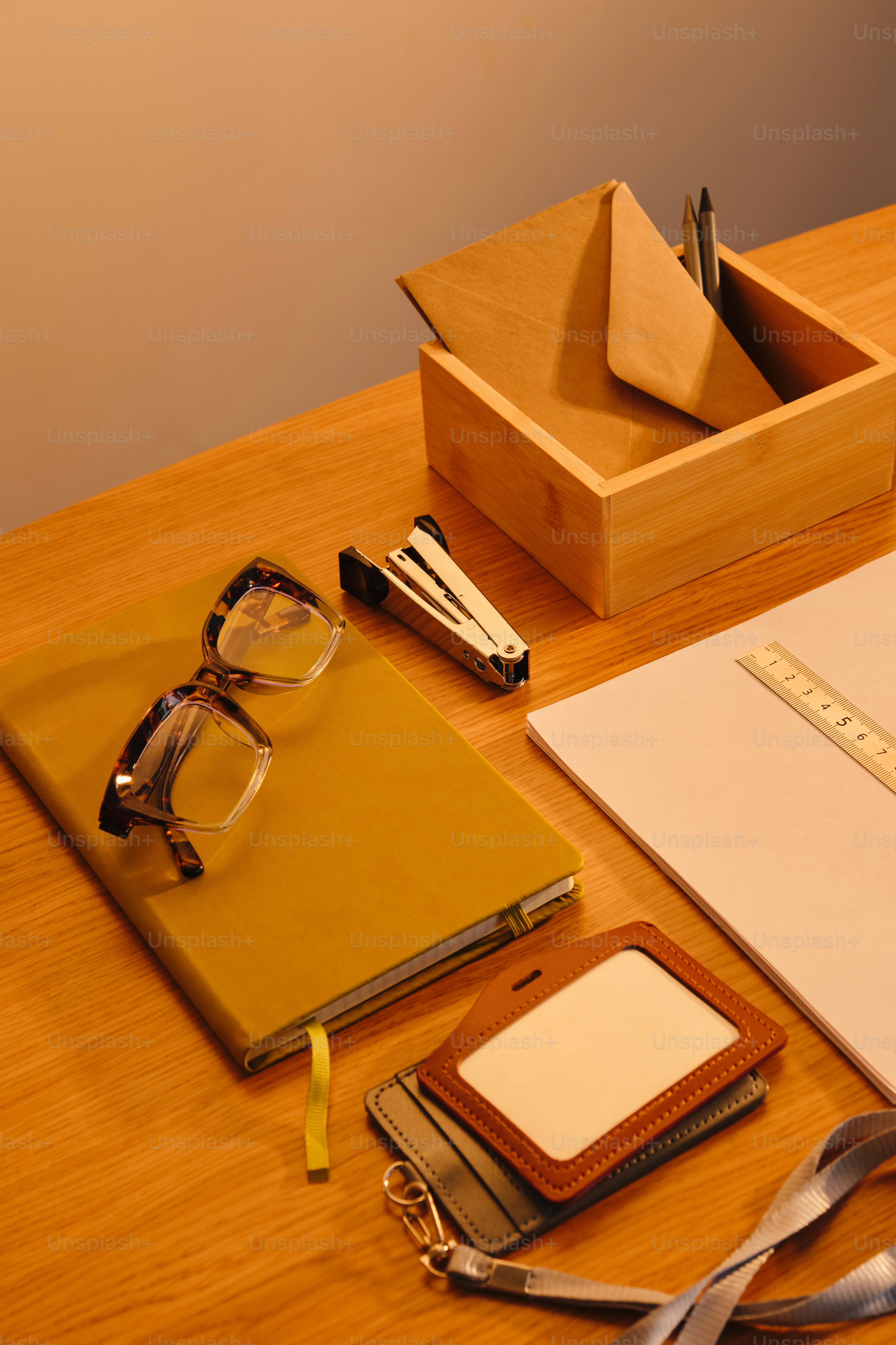 Desk with glasses, notebook, stapler, and badge holder. photo – Office ...