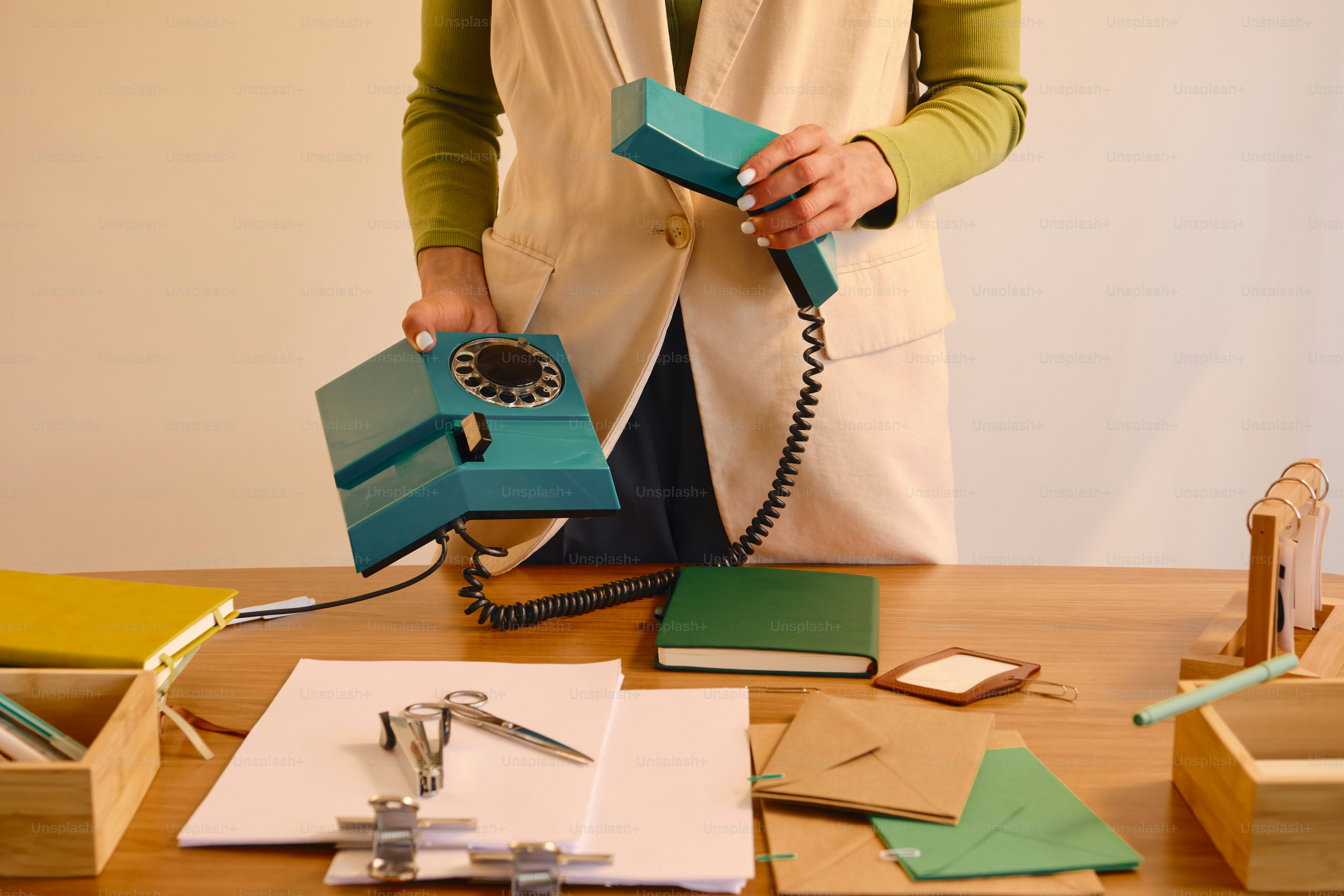 Woman holding a vintage turquoise rotary phone