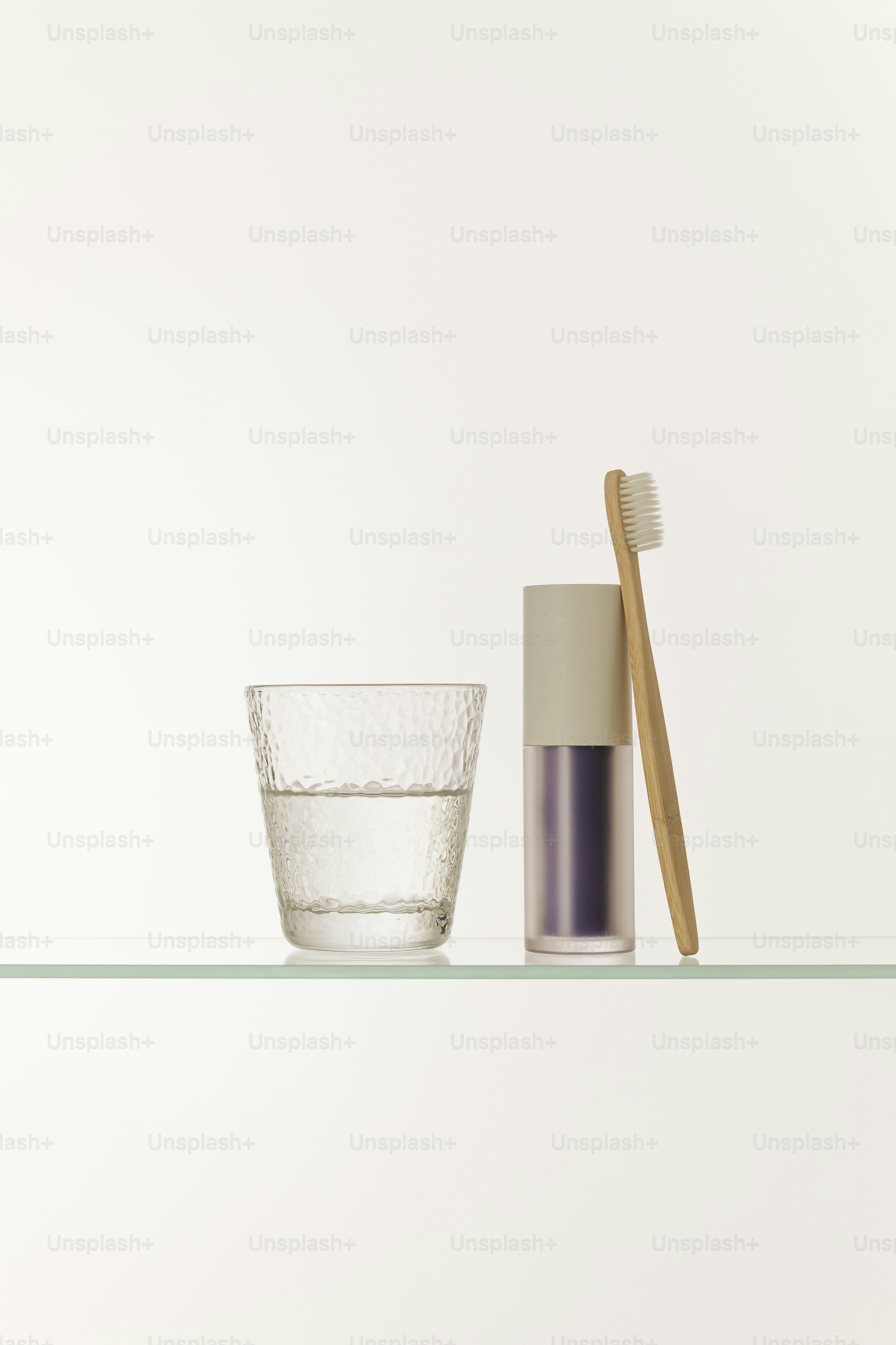 A glass of water and a toothbrush with toothpaste. photo – Minimalist ...