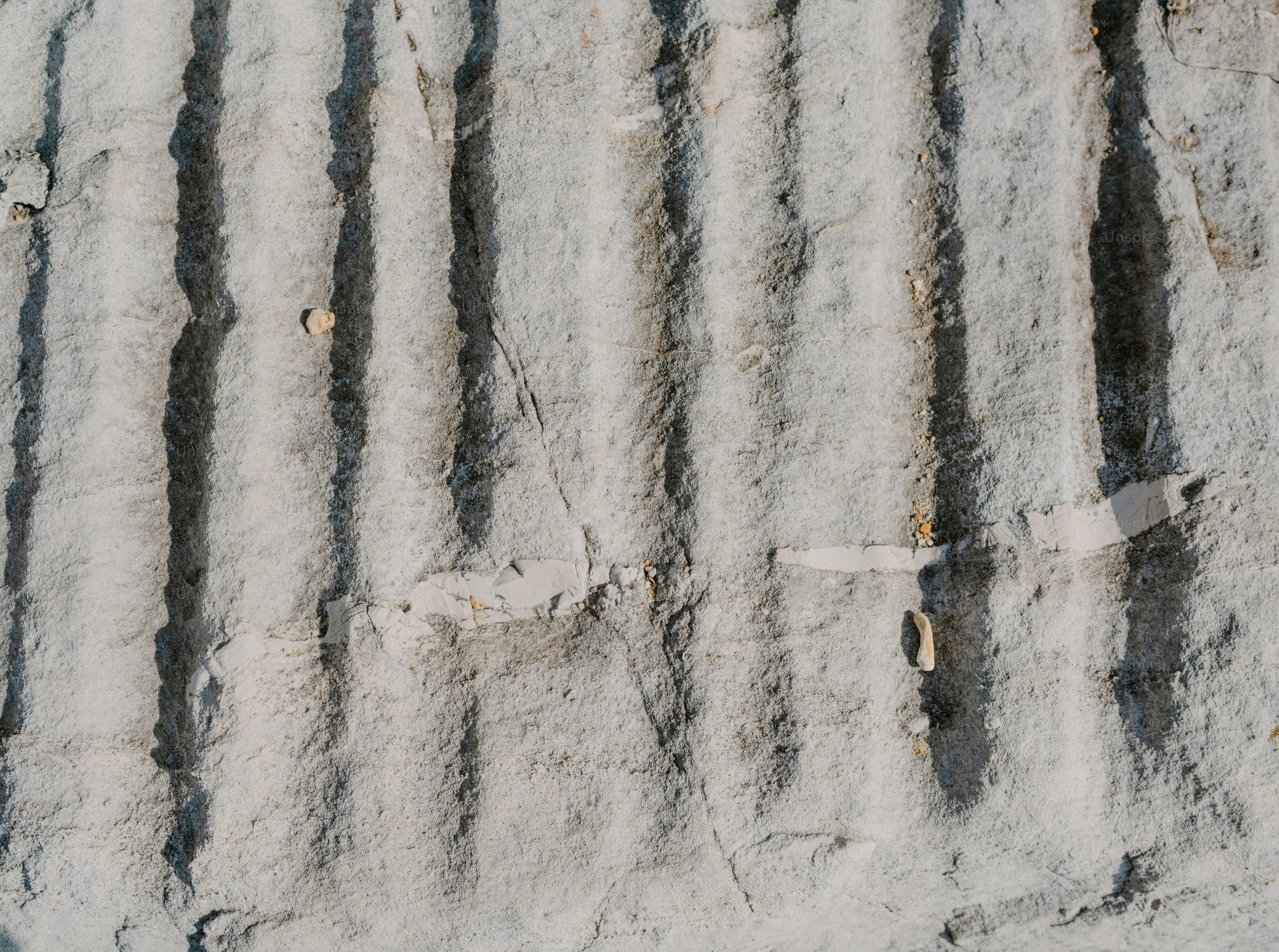 Close-up of textured gray stone with vertical grooves photo – Abstract ...