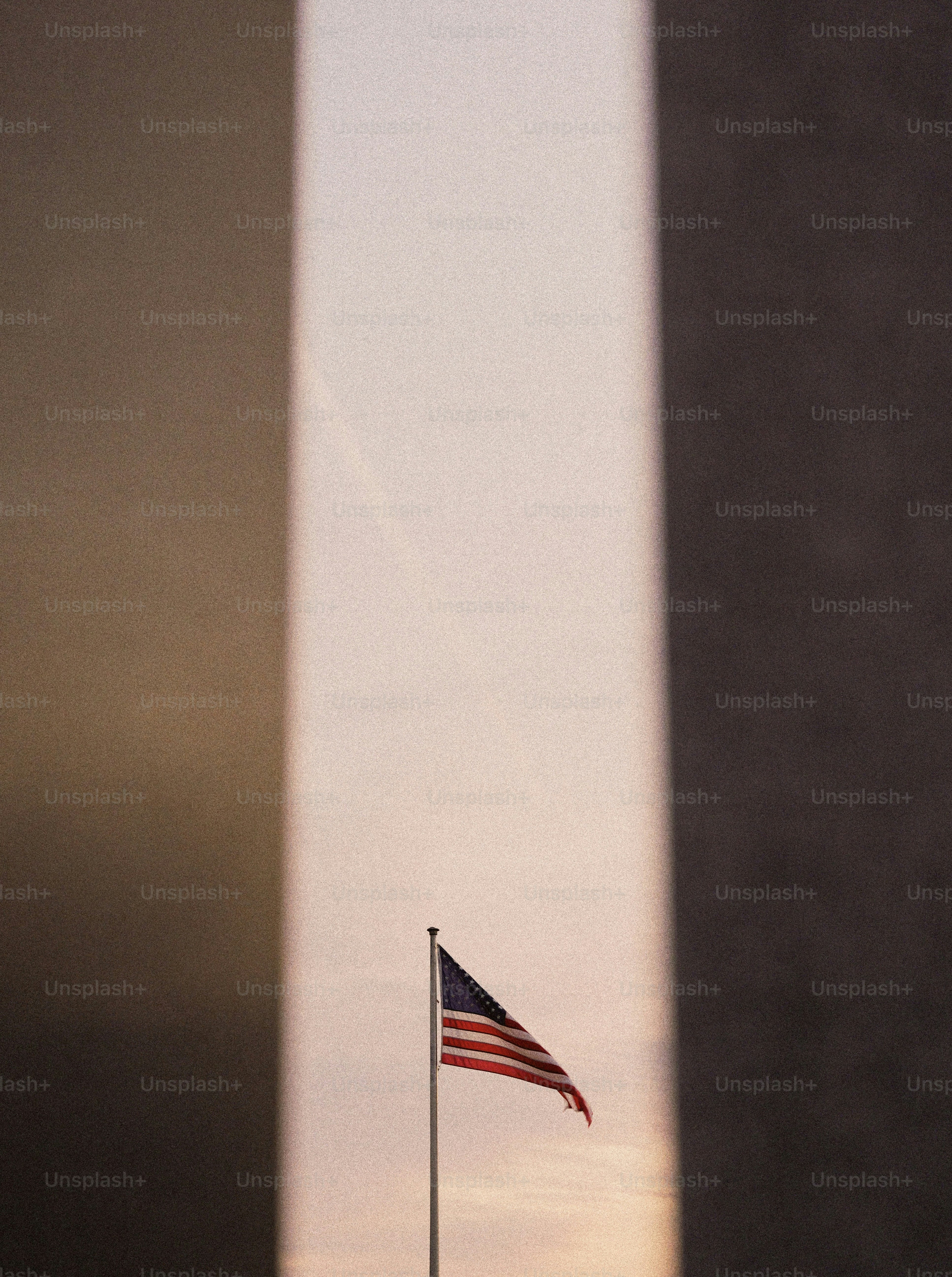 American flag flies near a tall monument