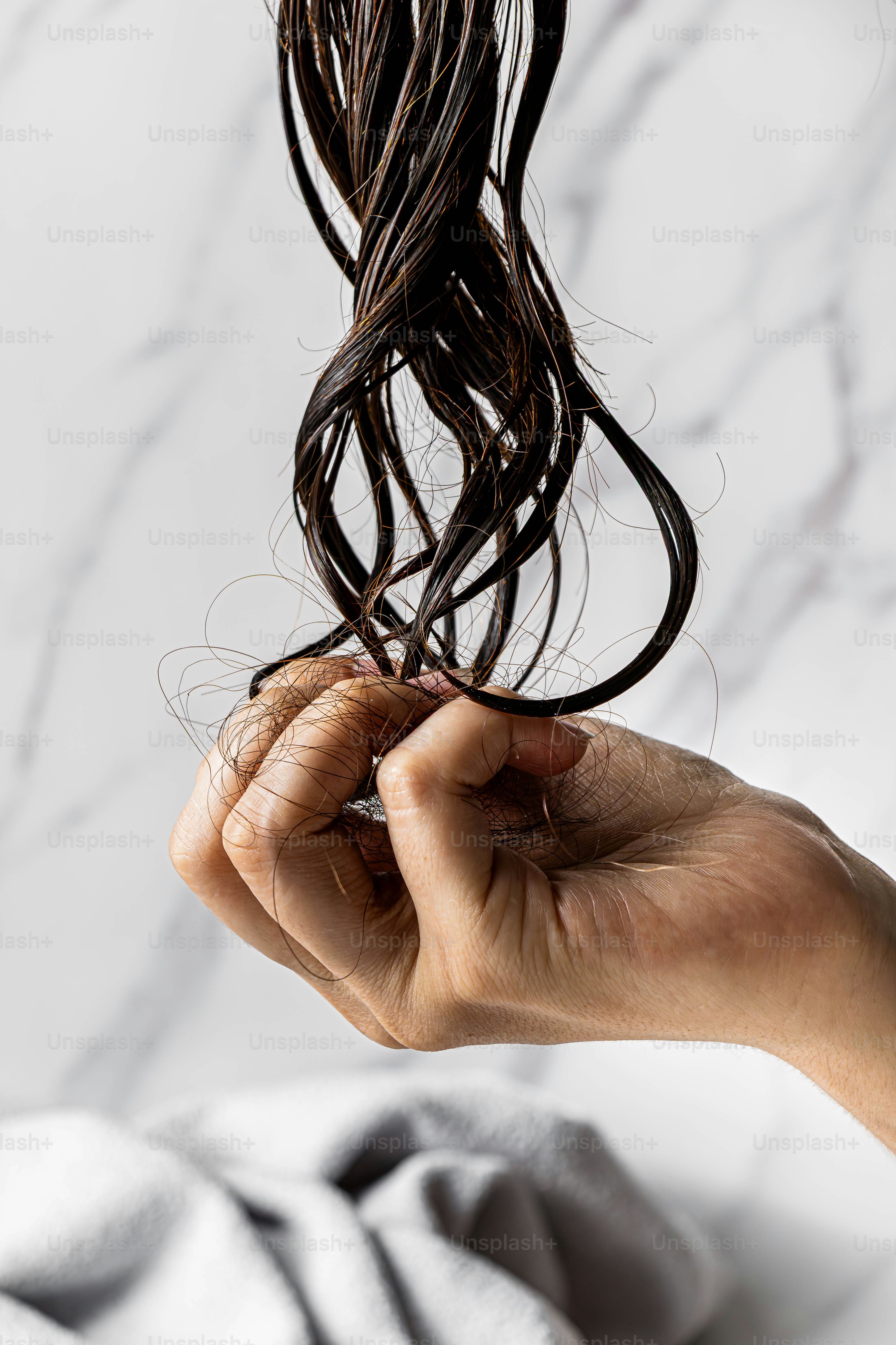 Hand holding a clump of fallen hair photo – Hand Image on Unsplash