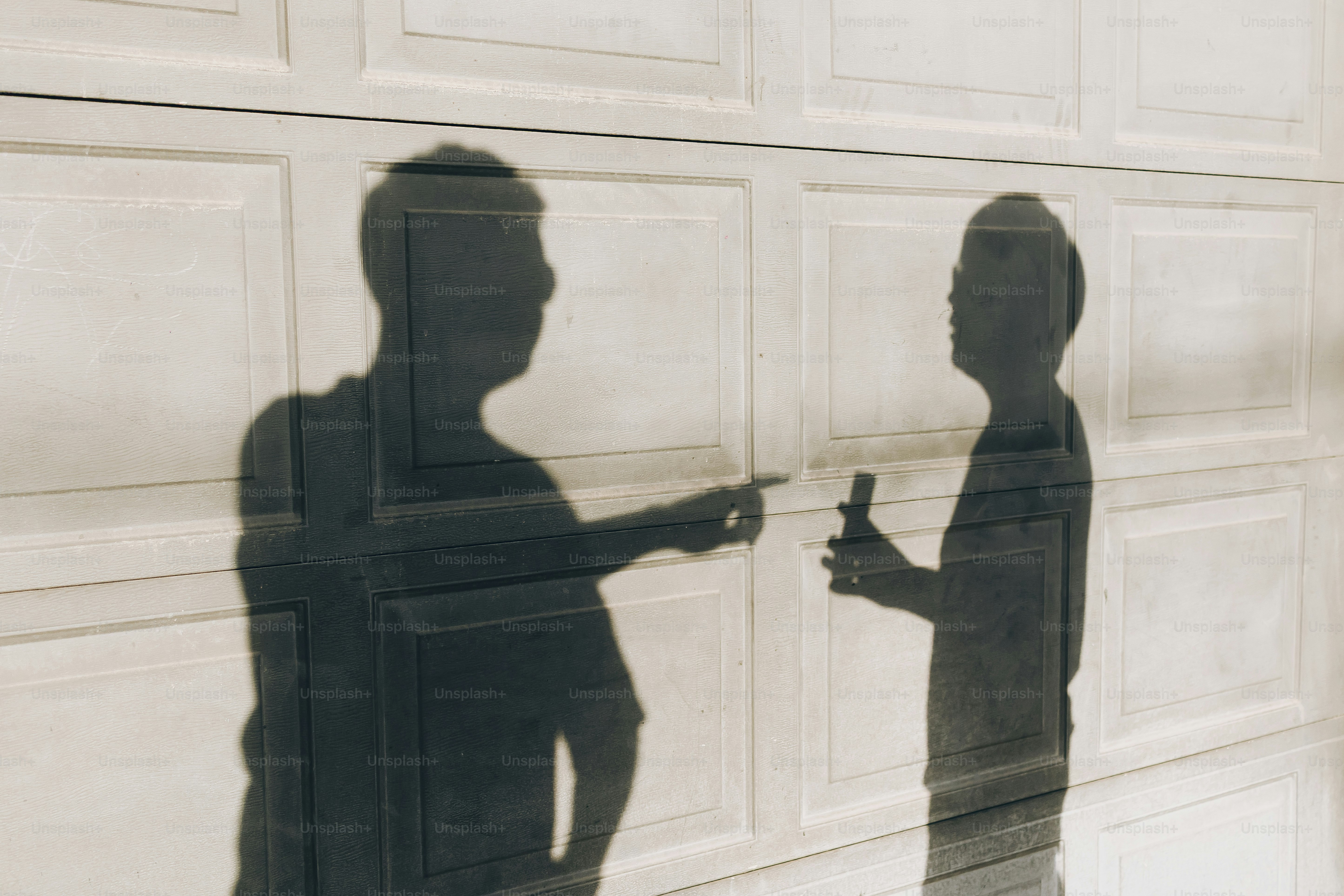 Shadows of two people talking on a wall photo – Portrait Image on Unsplash