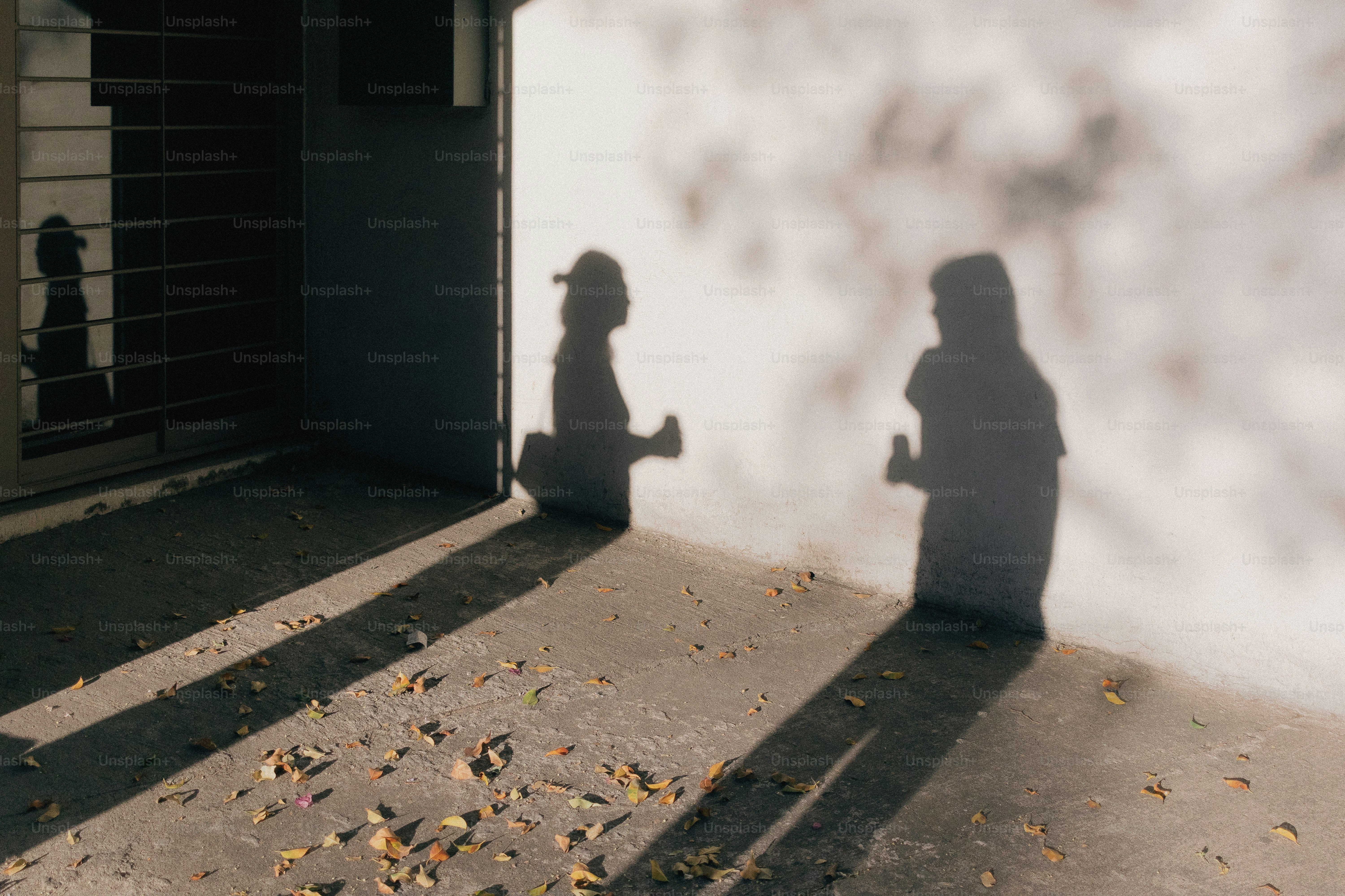 Two people's shadows conversing on a wall. photo – Portrait Image on ...