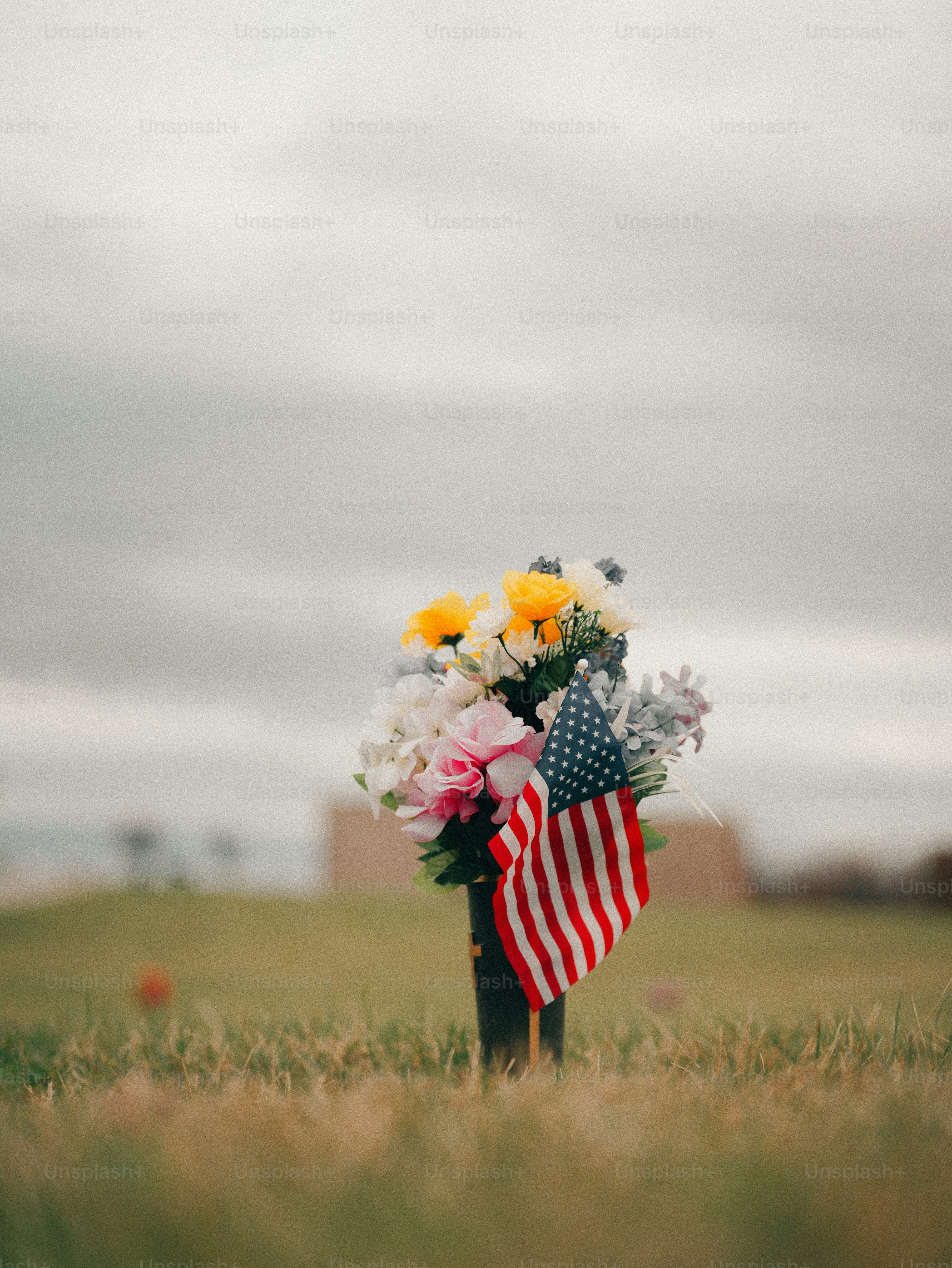 Flowers and american flag at a grave