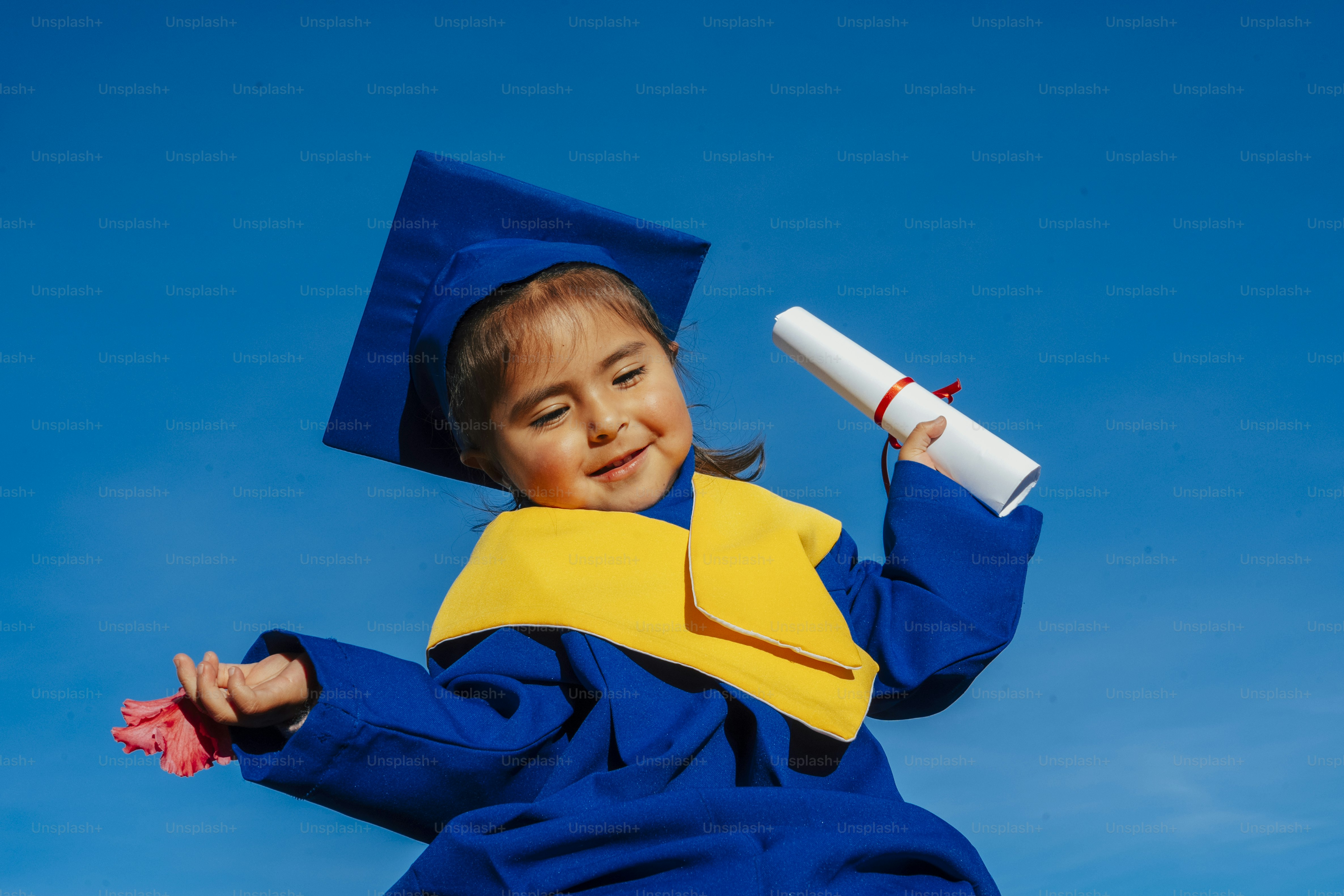 A smiling girl in a graduation cap holds a diploma. photo – Education ...