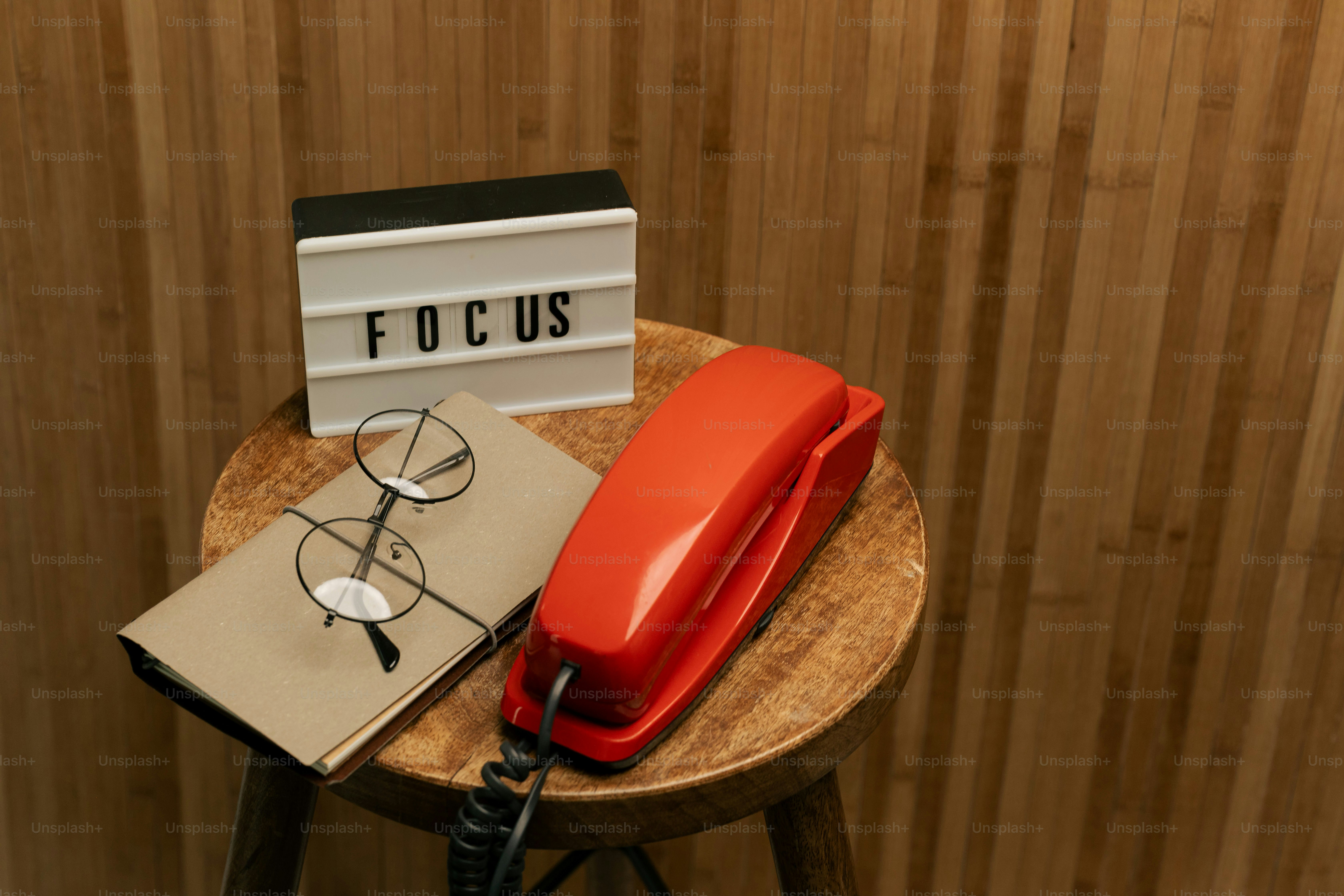 Red telephone, glasses, and lightbox on stool