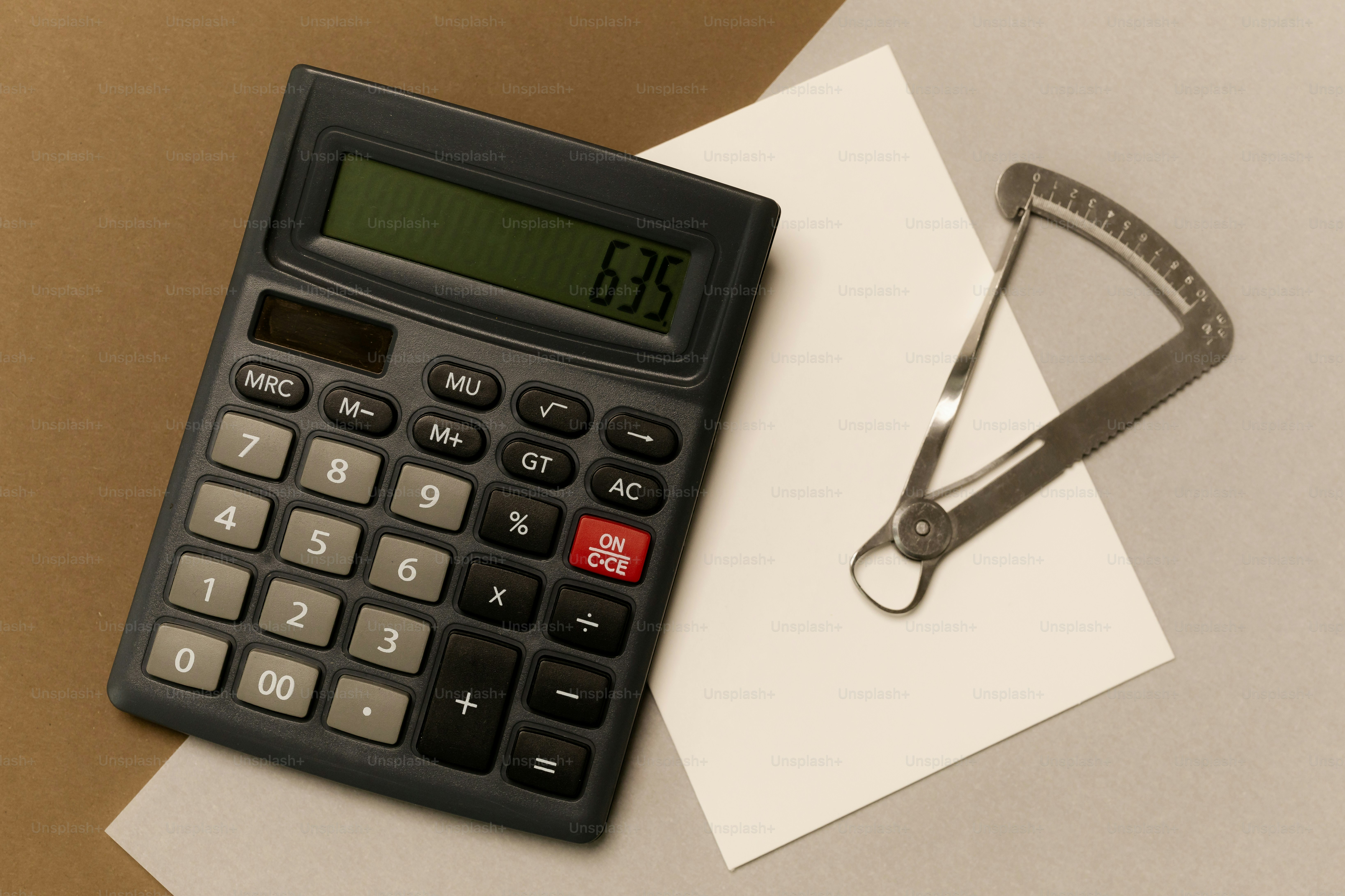 Calculator and calipers on a paper