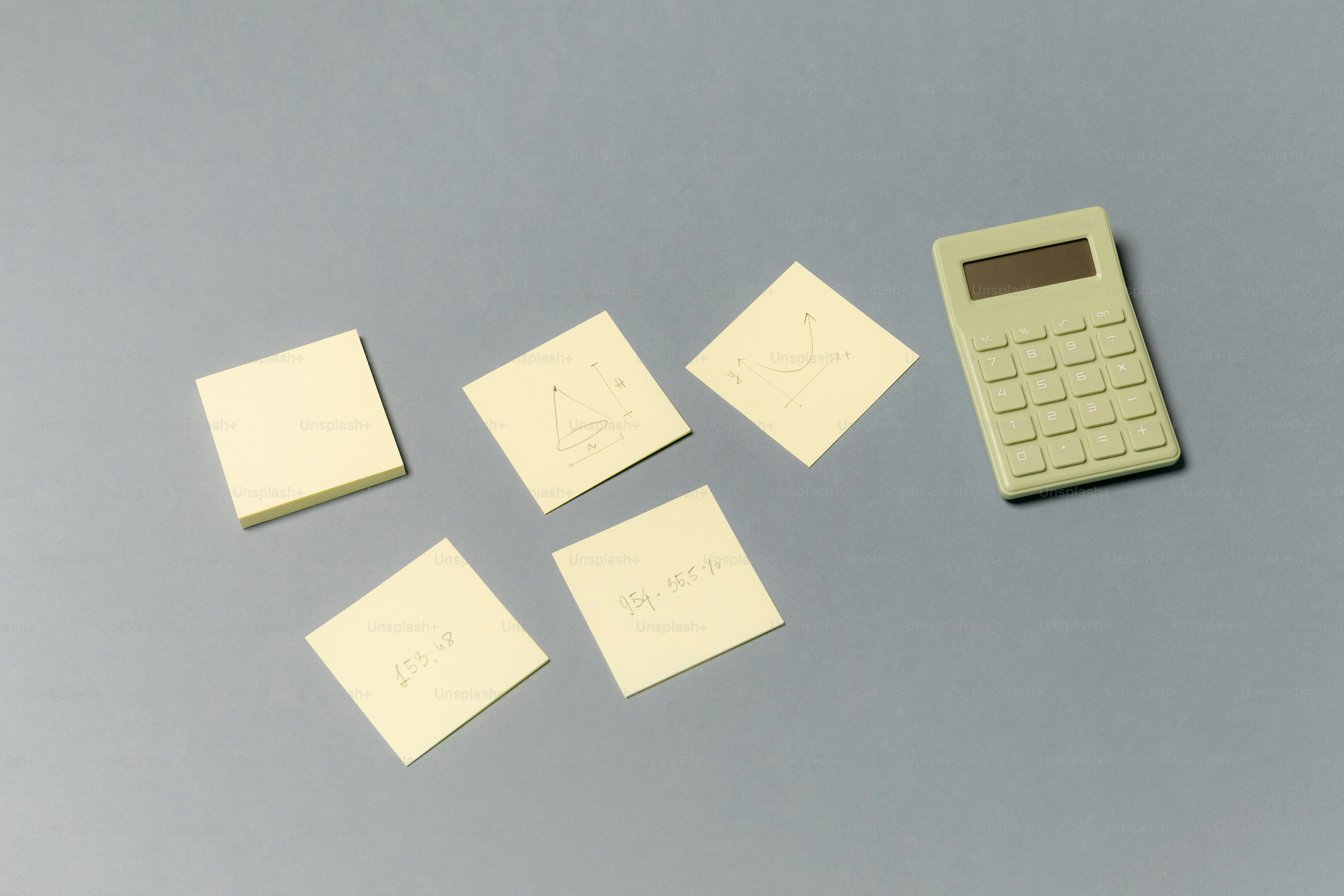 Calculator and sticky notes on a gray surface photo – Education Image ...