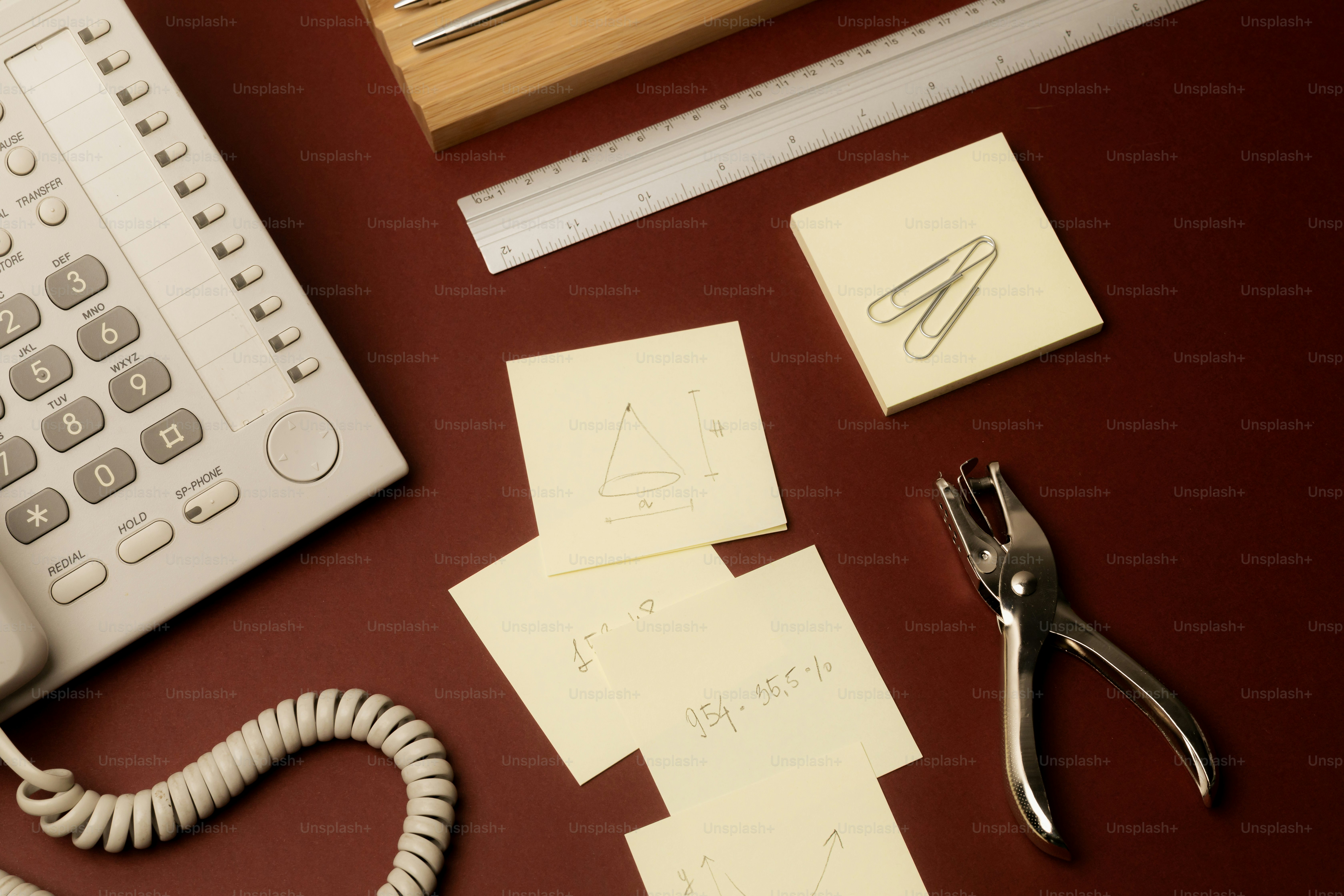 Desk with telephone, sticky notes, and office supplies