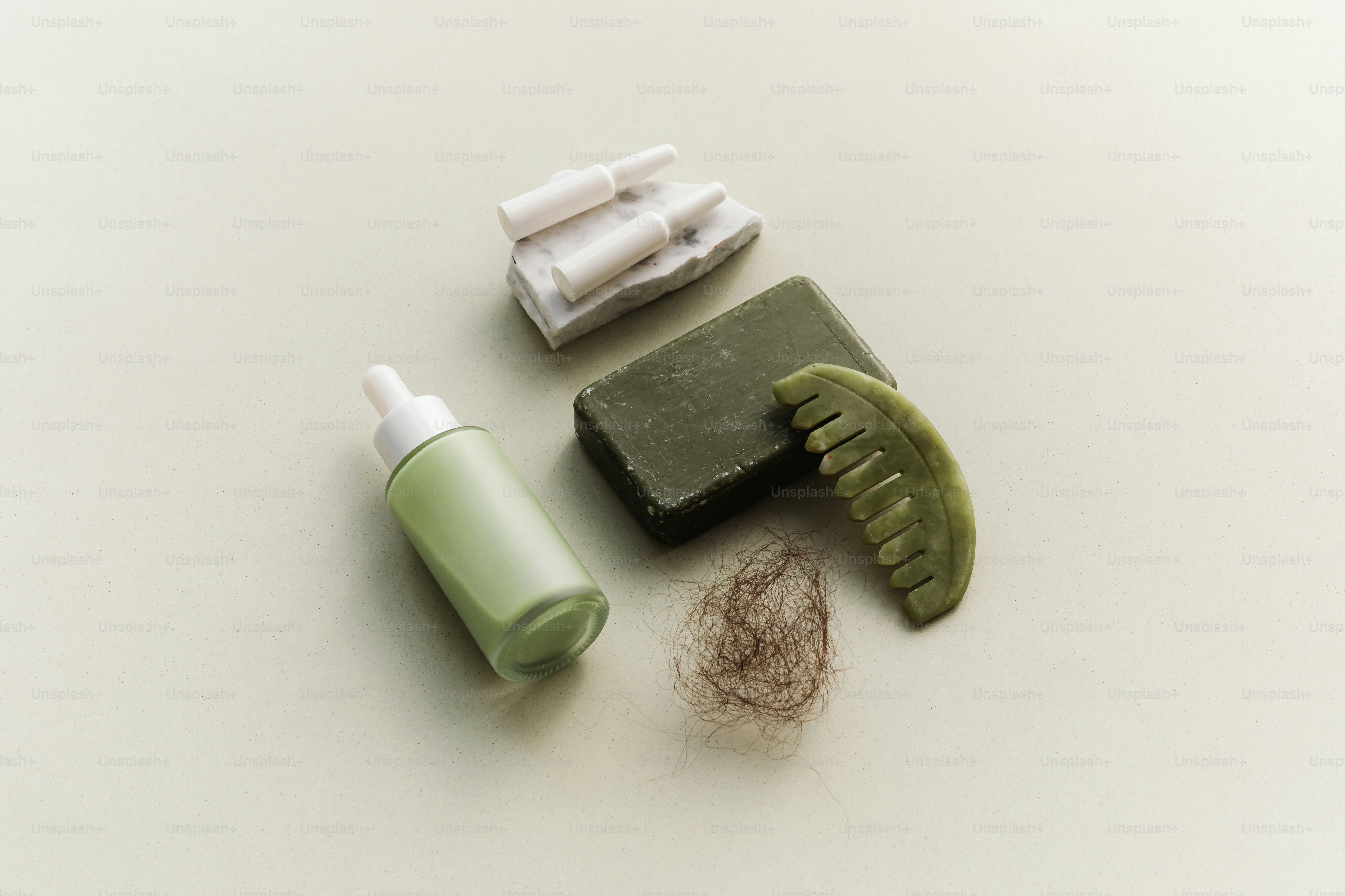 Hair loss treatment products with comb and hair sample.