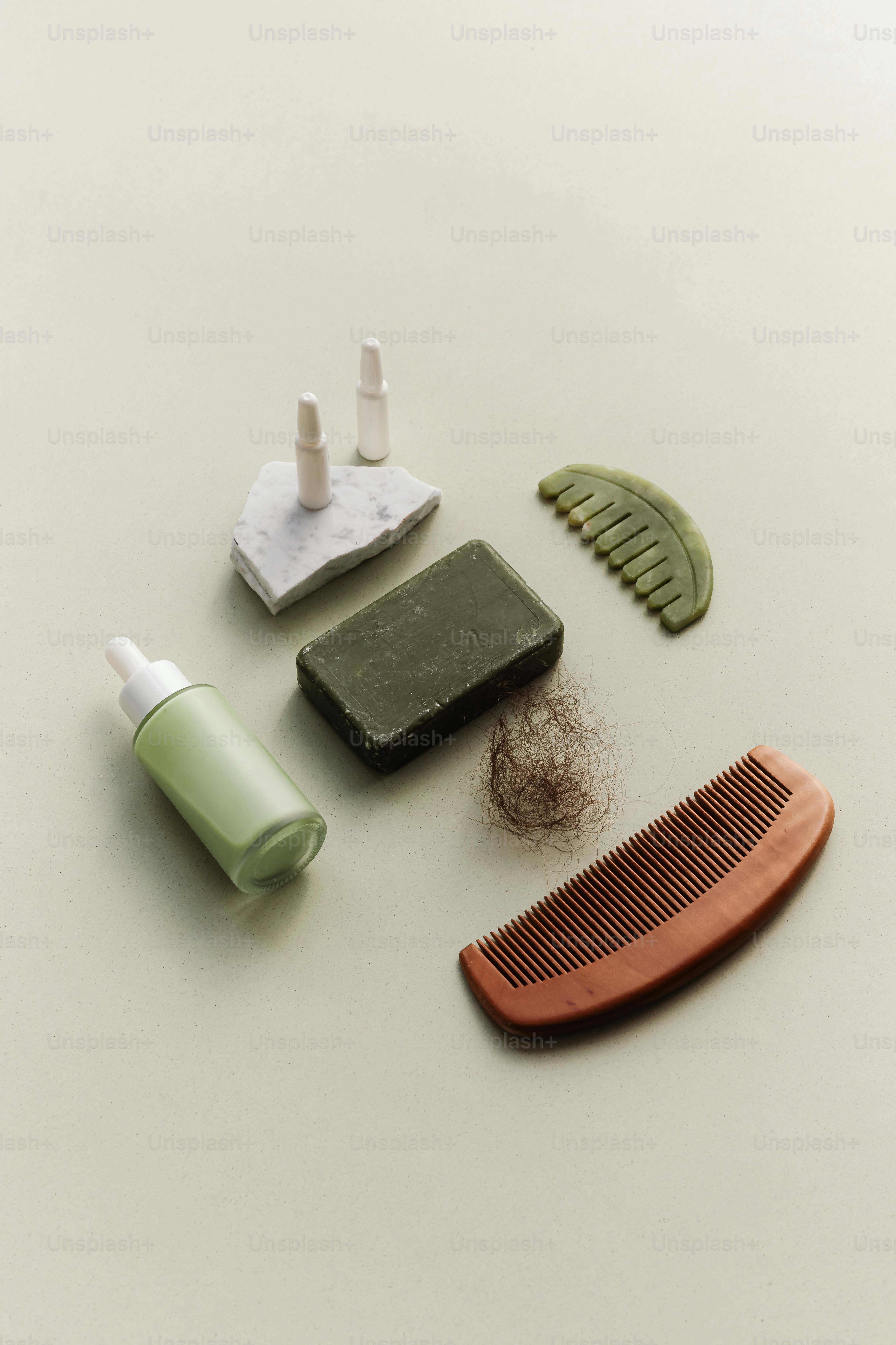 Hair care products and tools arranged on a light background.