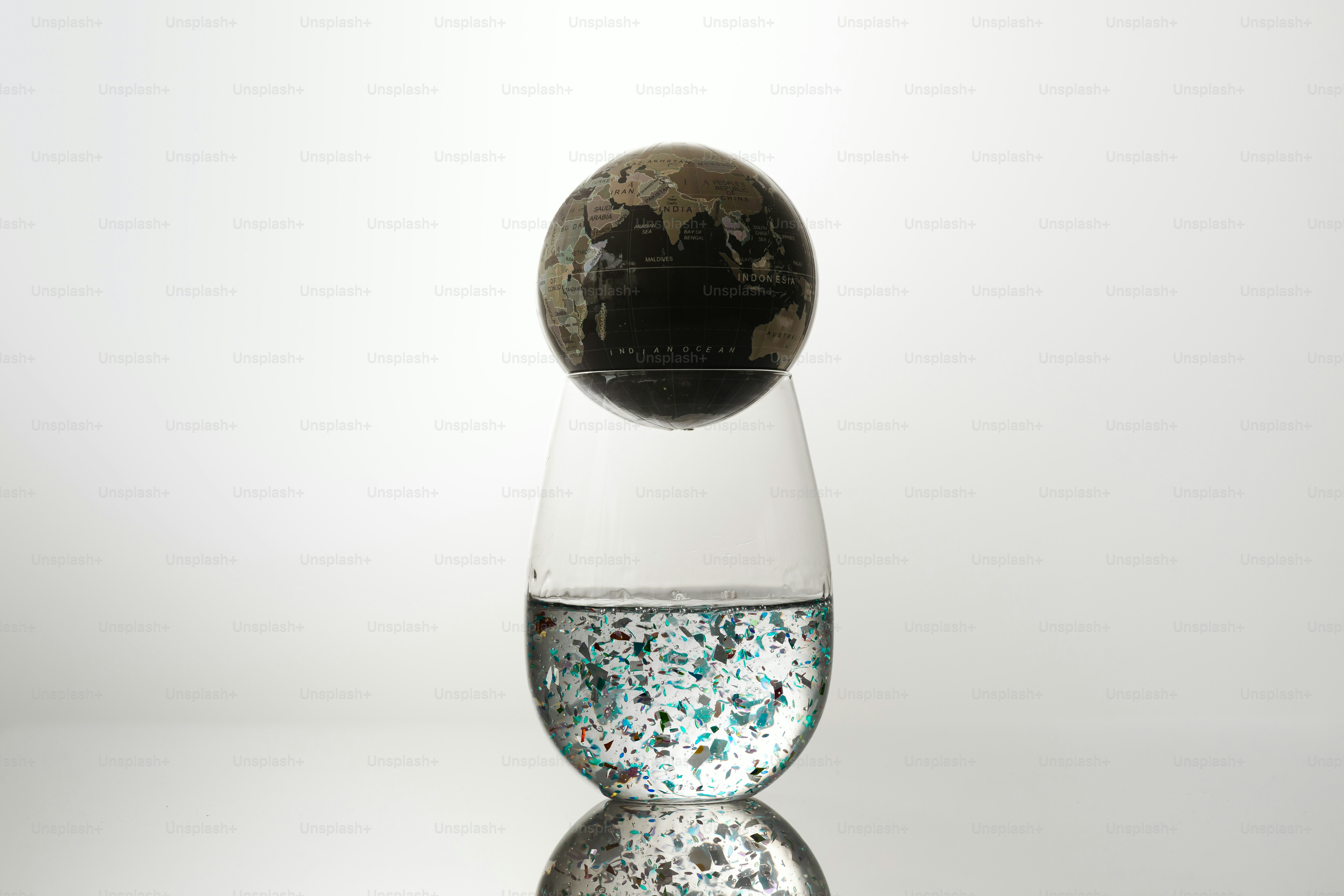 Globe balanced on a glass of water
