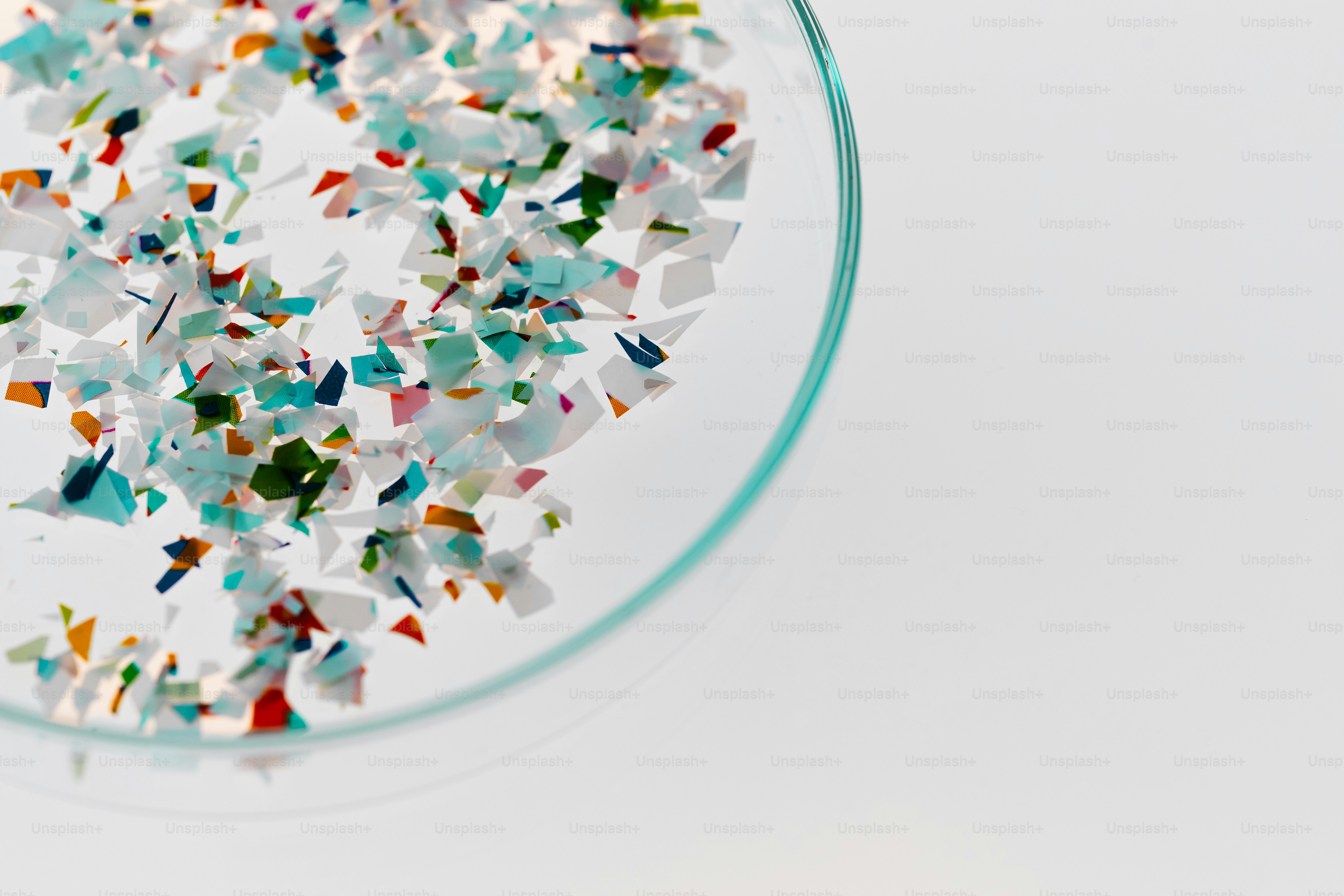 Colorful confetti scattered in a petri dish
