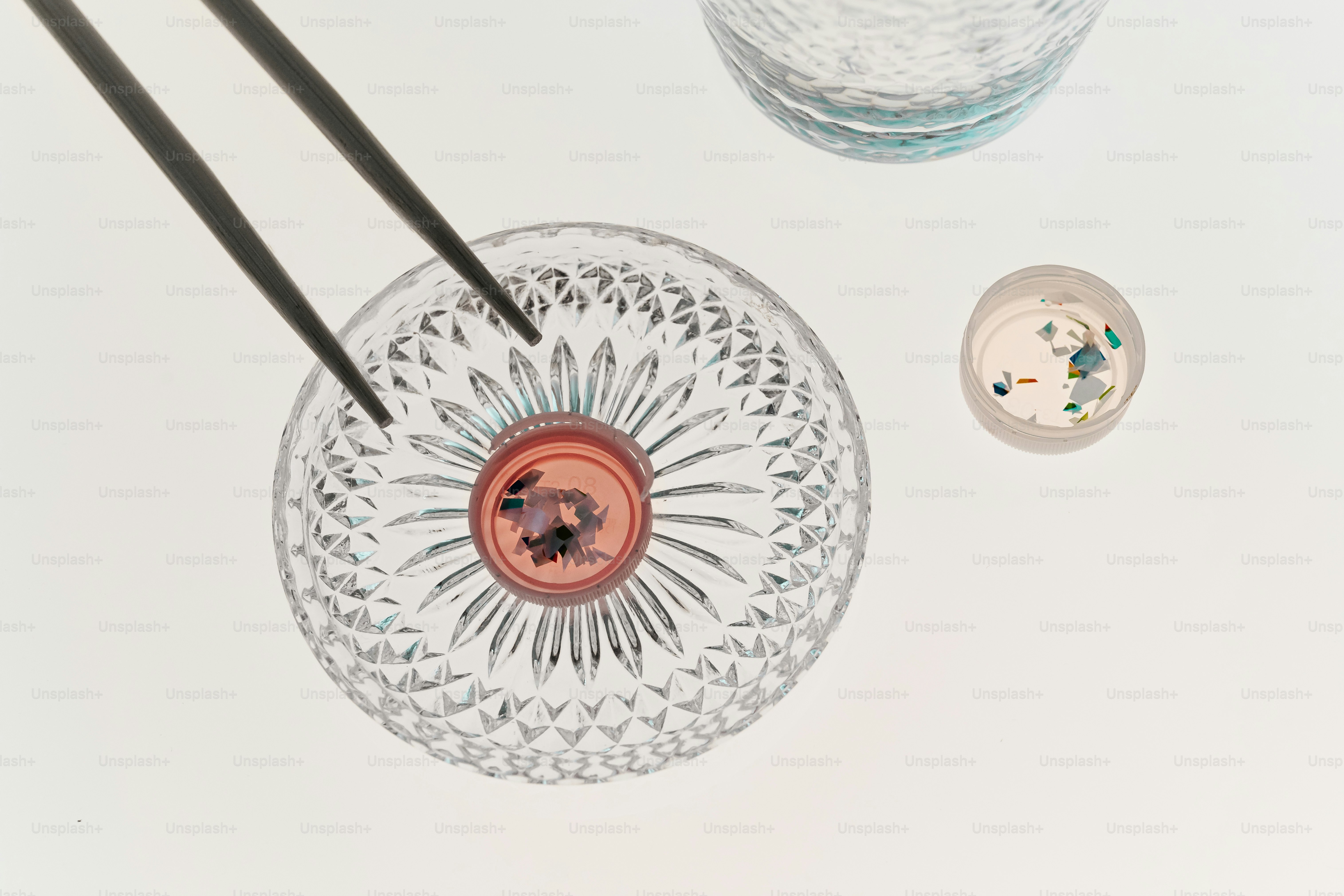 Chopsticks holding food over a decorative bowl