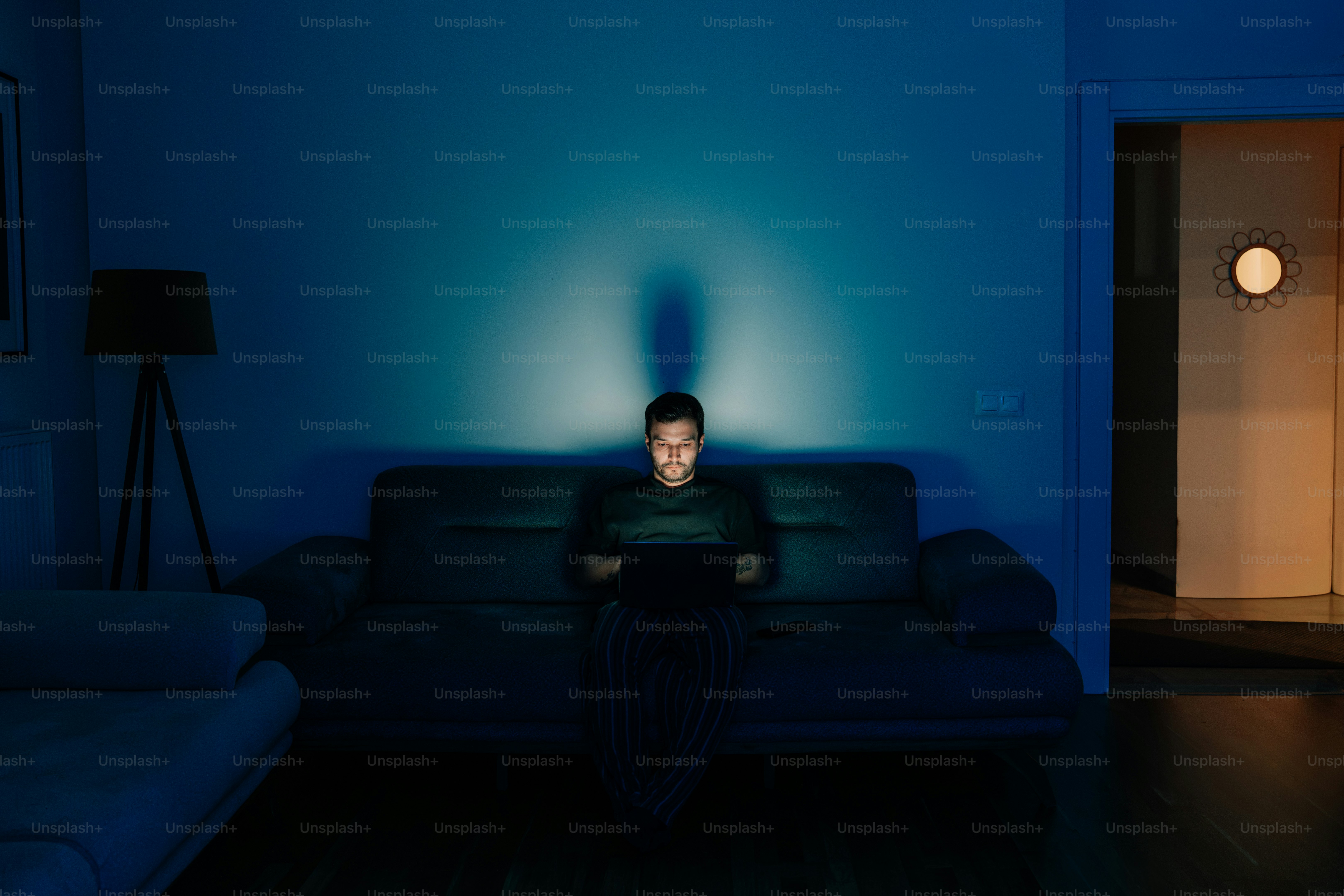 Man illuminated by phone screen in dark room photo – Tech Image on Unsplash