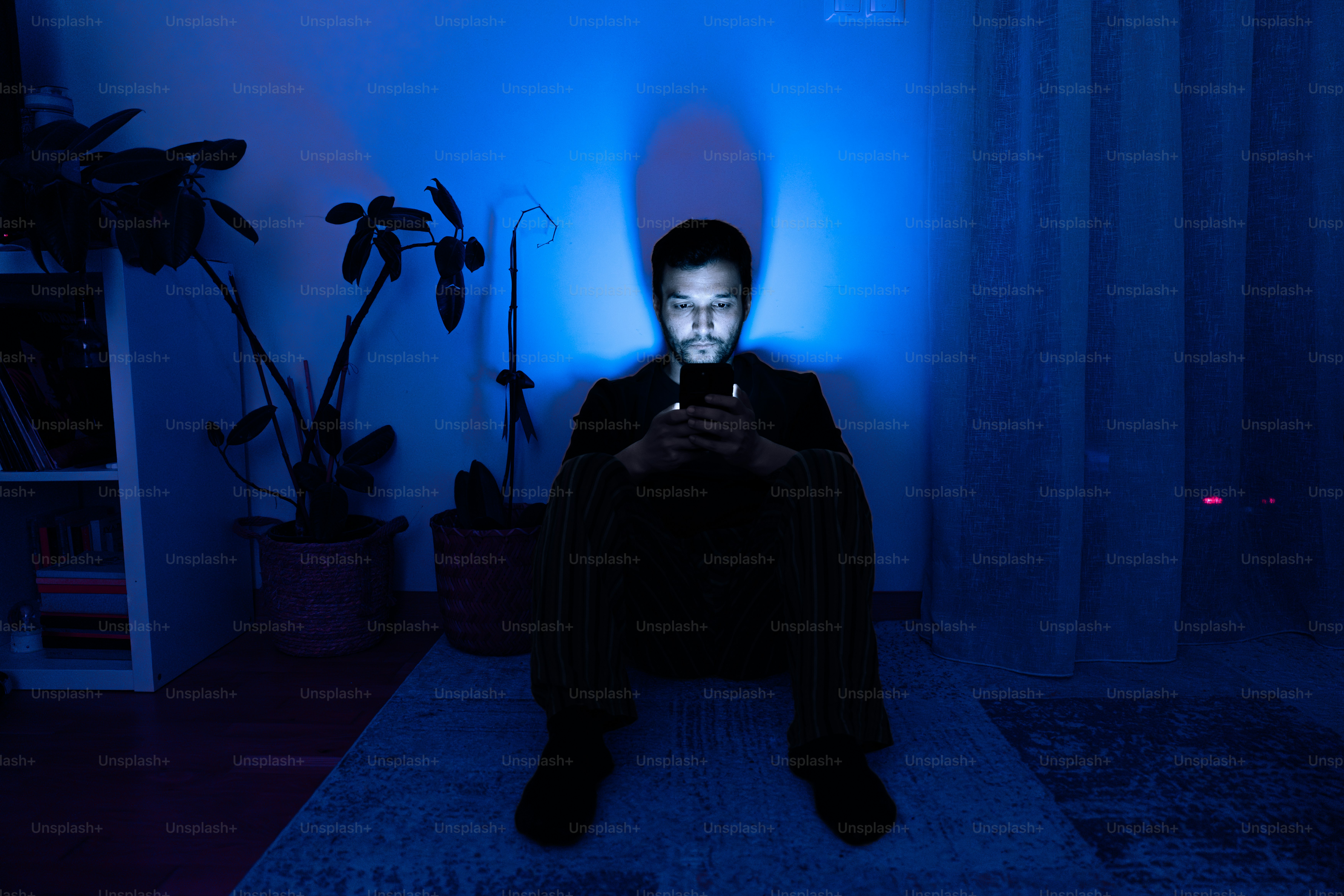 Man illuminated by phone screen in dark room photo – Tech Image on Unsplash