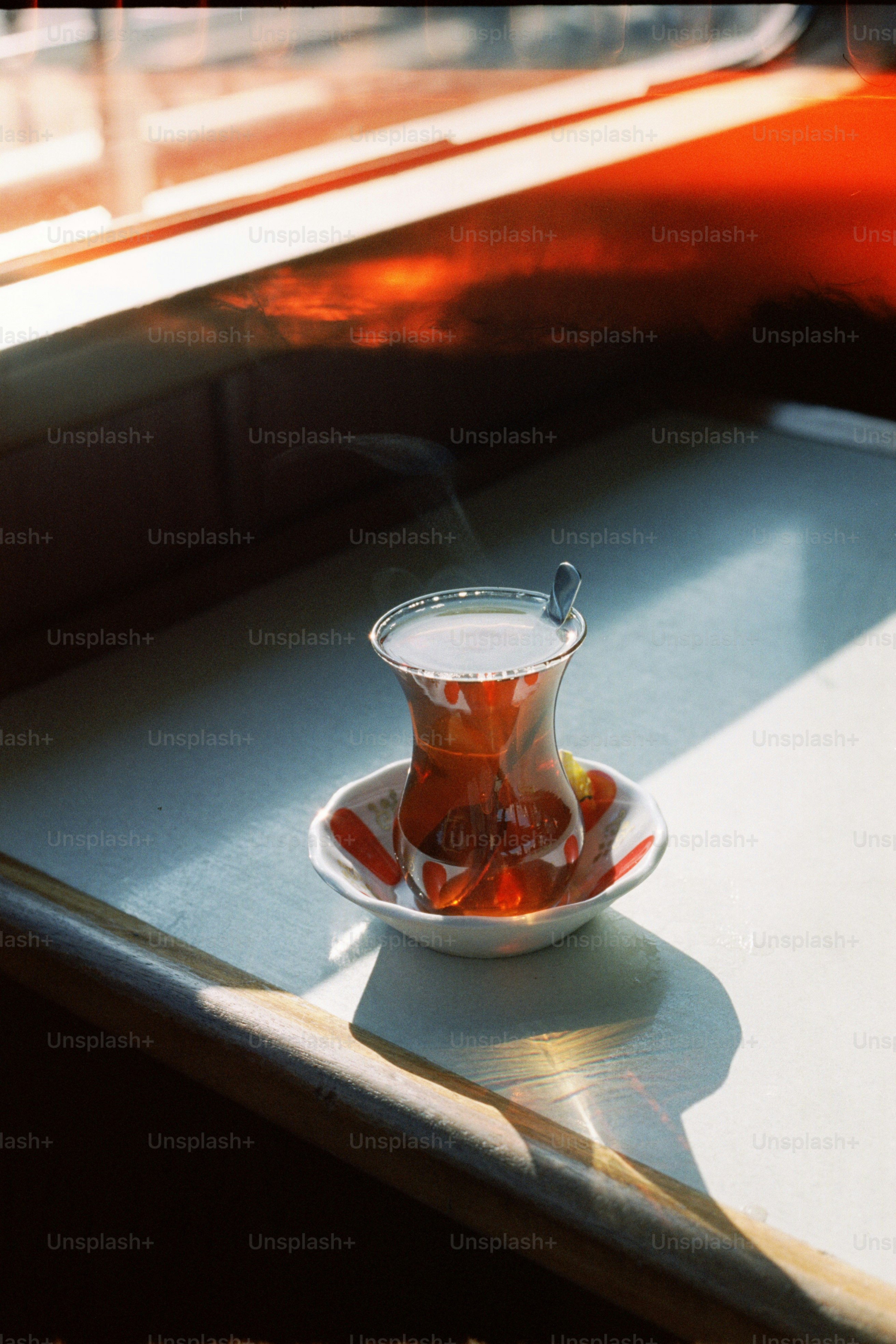 A glass of hot tea with steam rising. photo – Tea Image on Unsplash