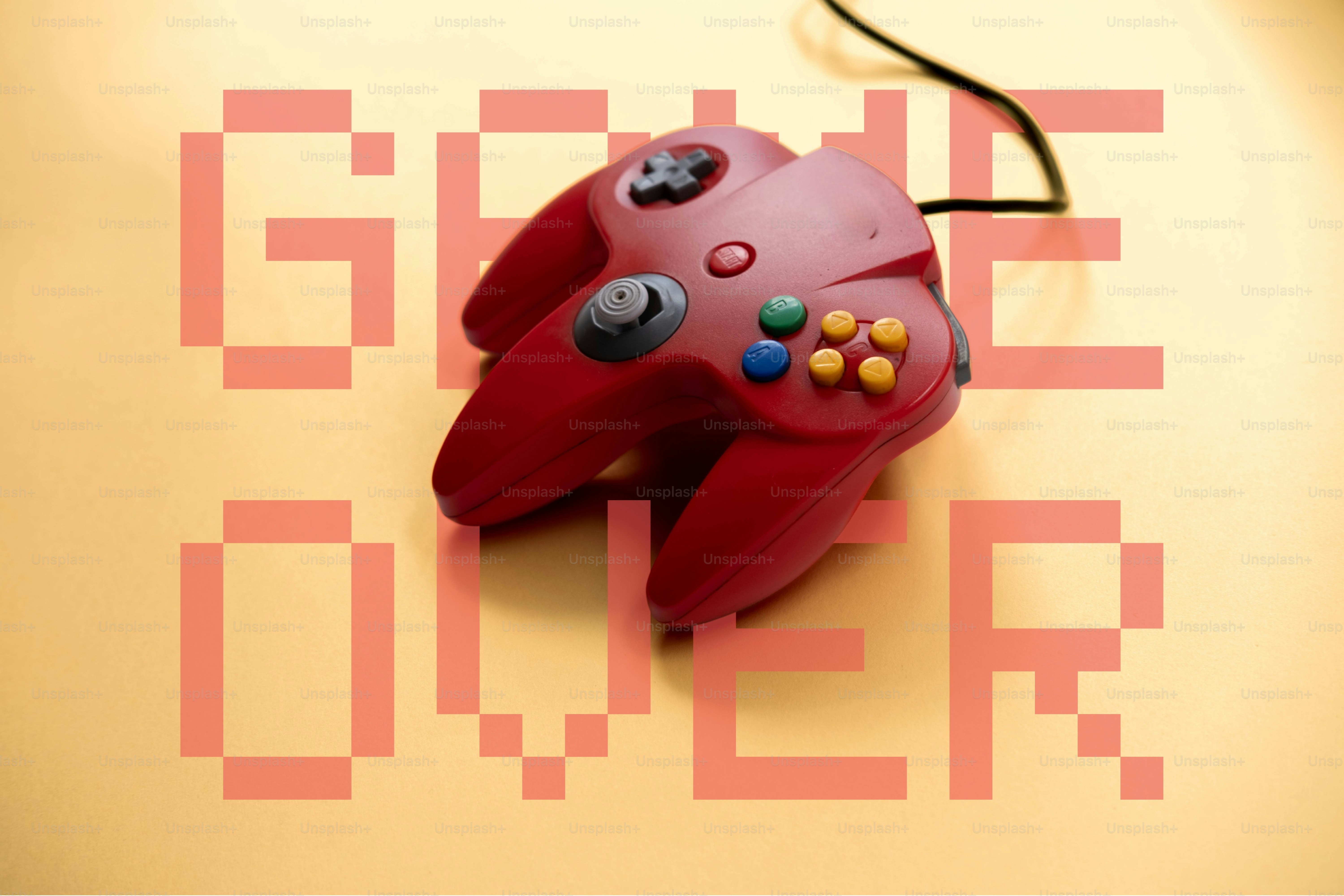 Pengontrol video game merah dengan teks "game over".
