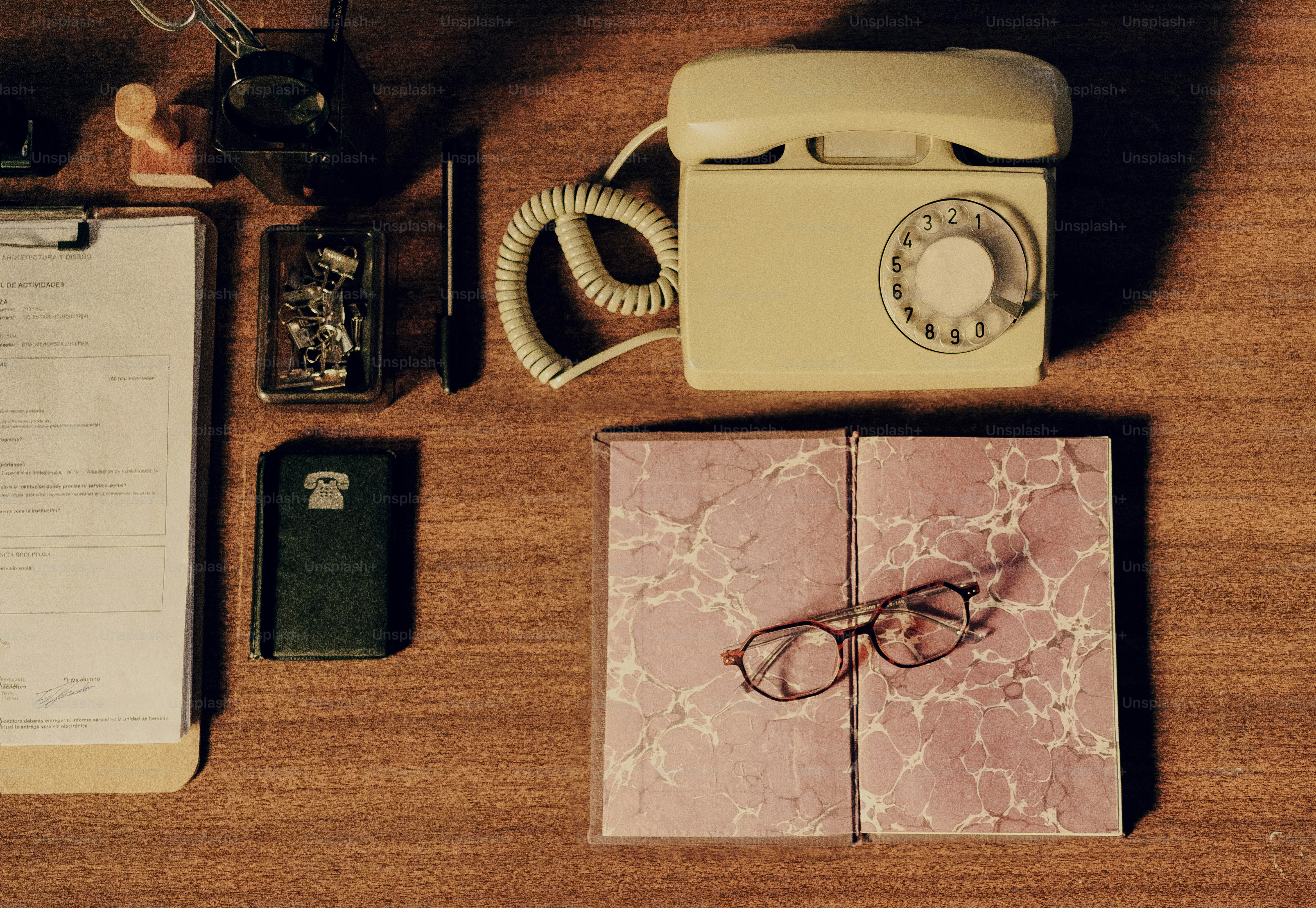 Vintage desk with rotary phone and eyeglasses