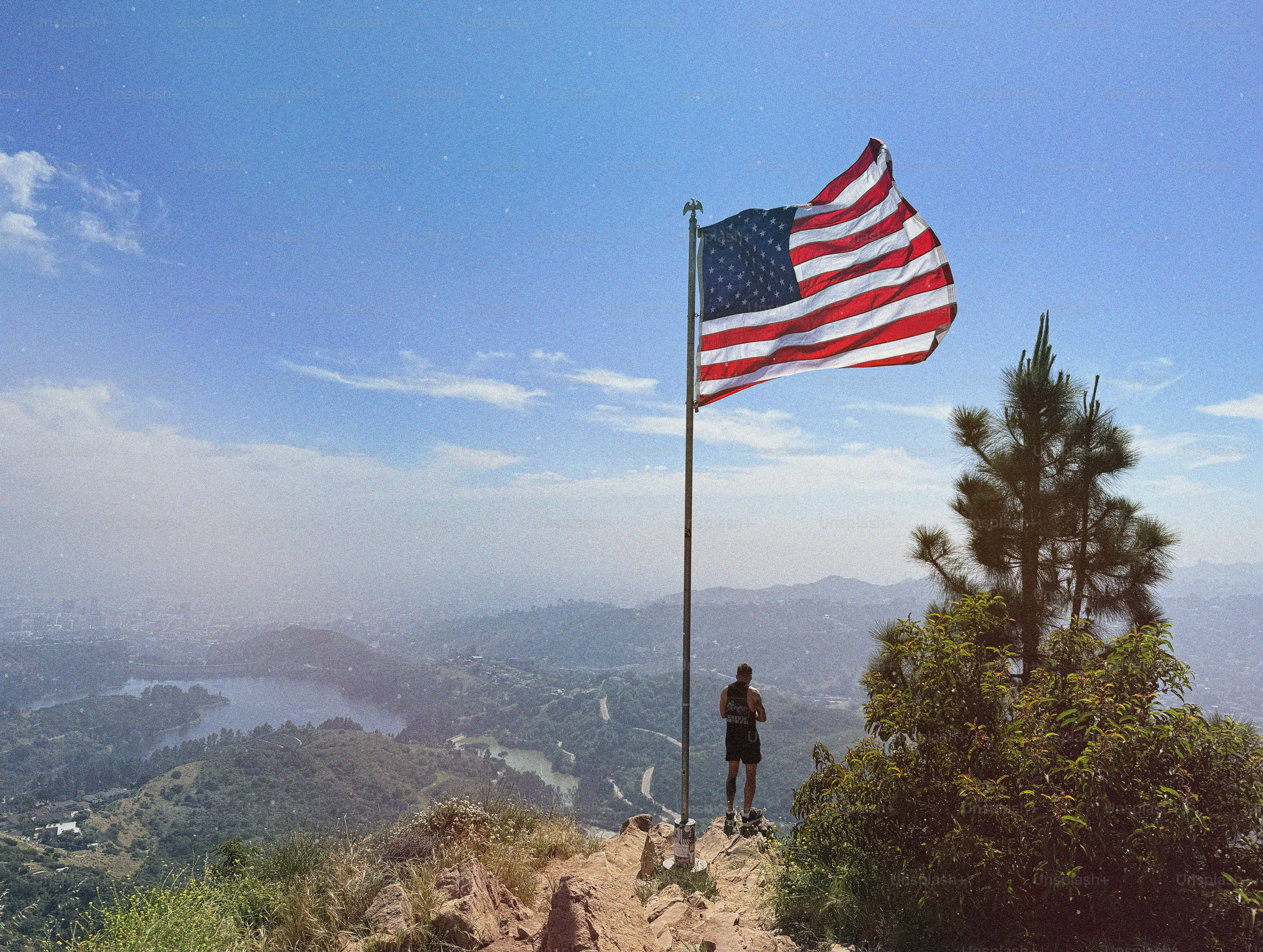 American flag flying high above scenic landscape