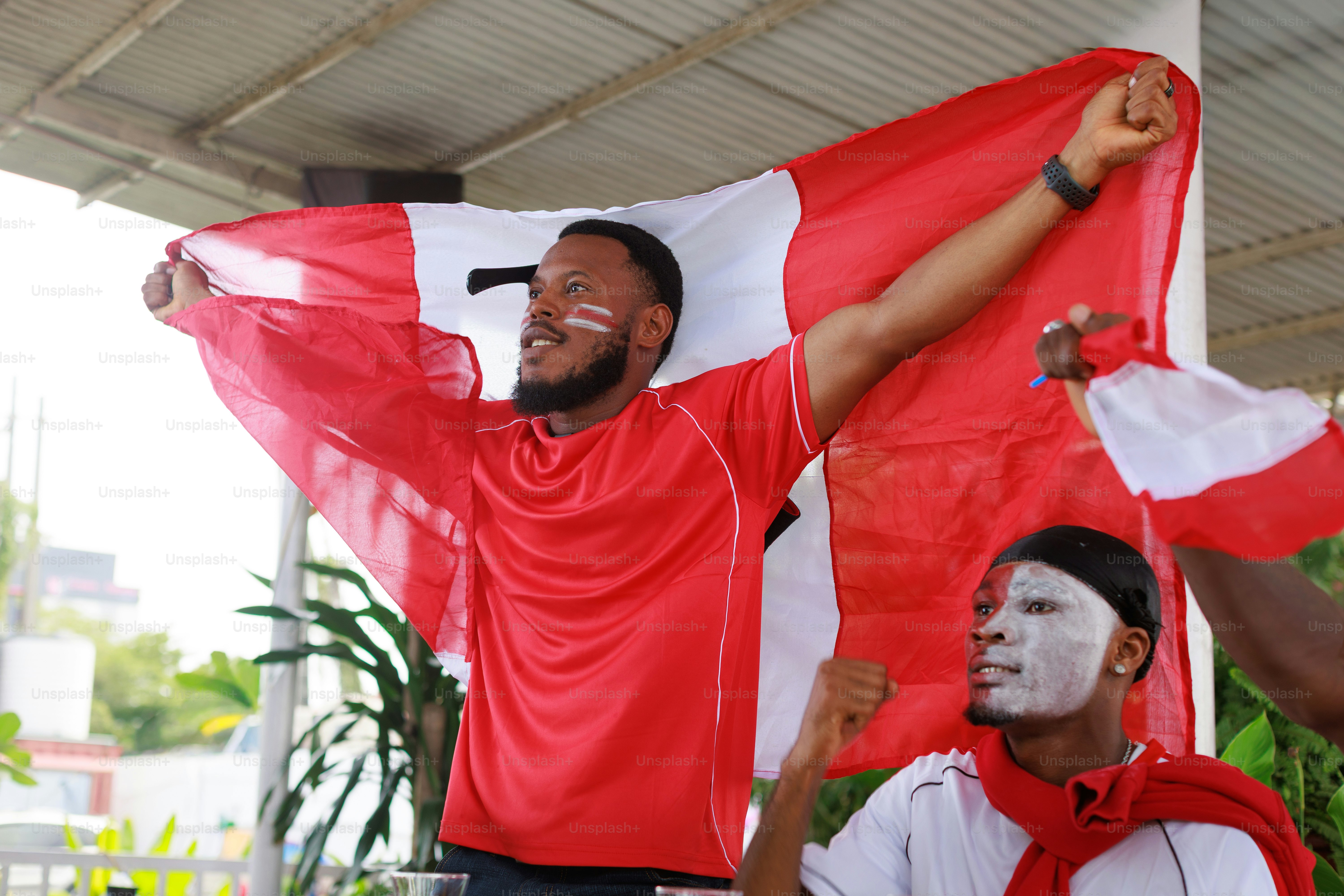 Pria berbaju merah mengibarkan bendera putih dan merah besar