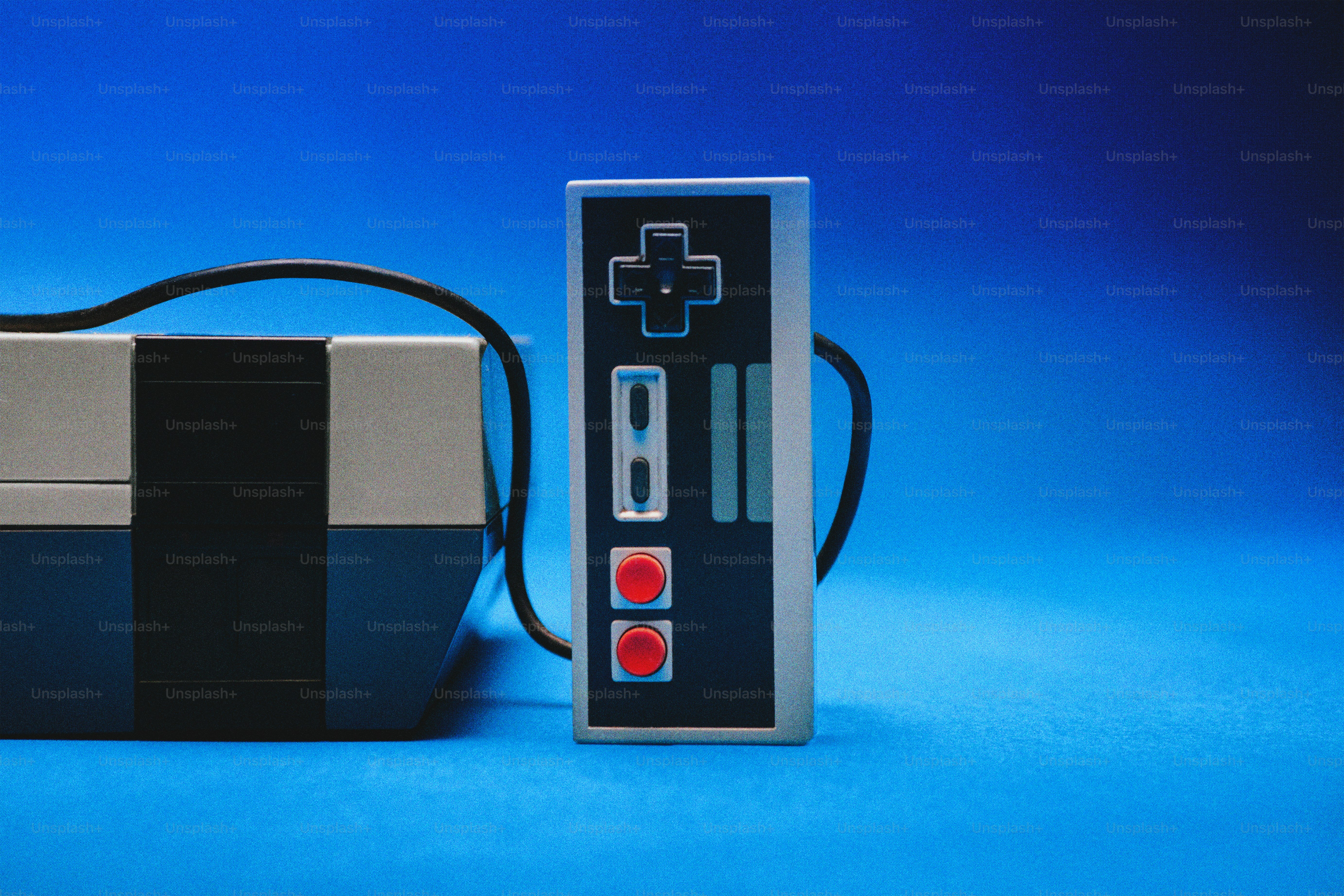 Retro-Videospielkonsole und Controller auf Blau