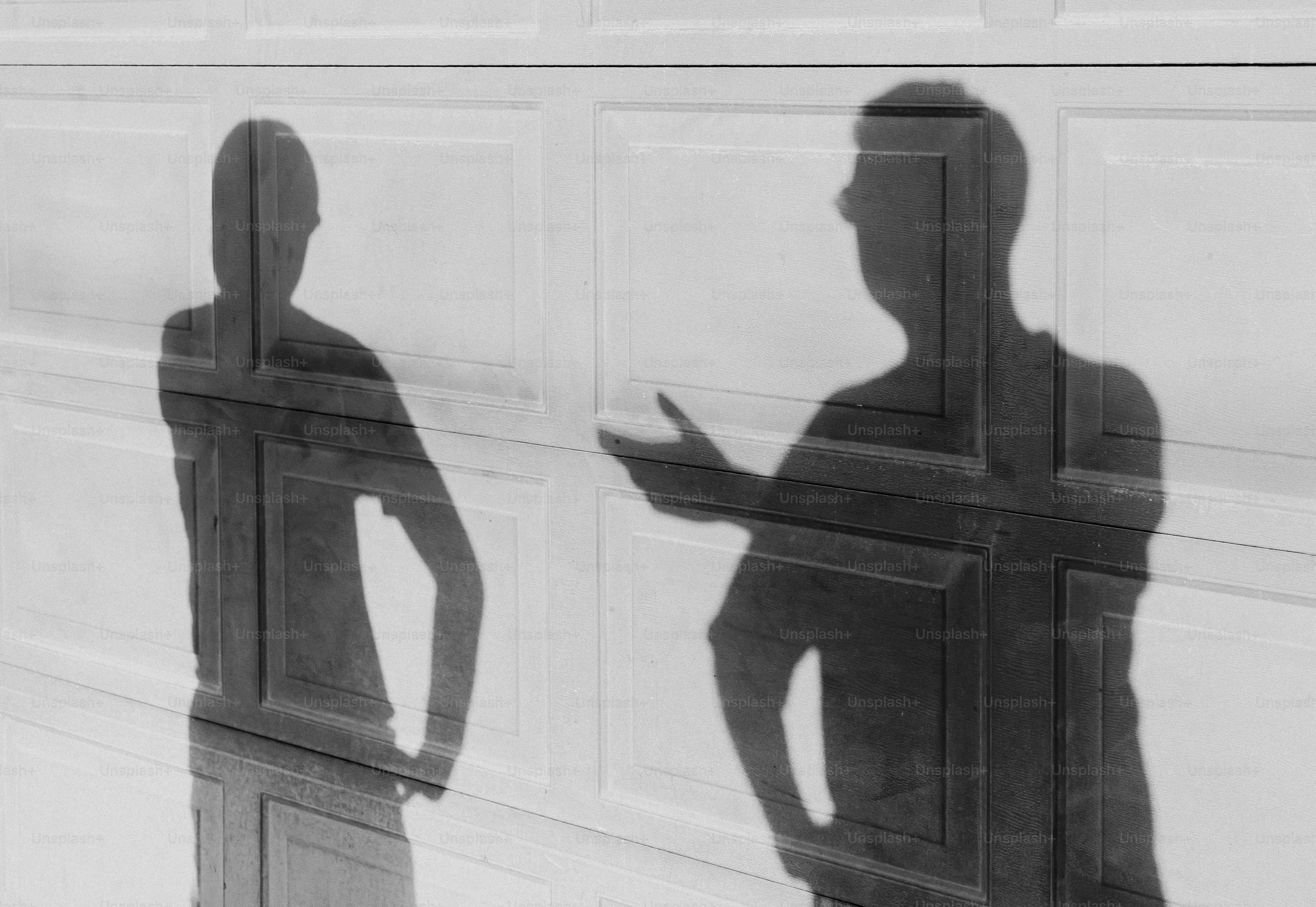 Two shadows of people talking against a wall photo – Abstract Image on ...