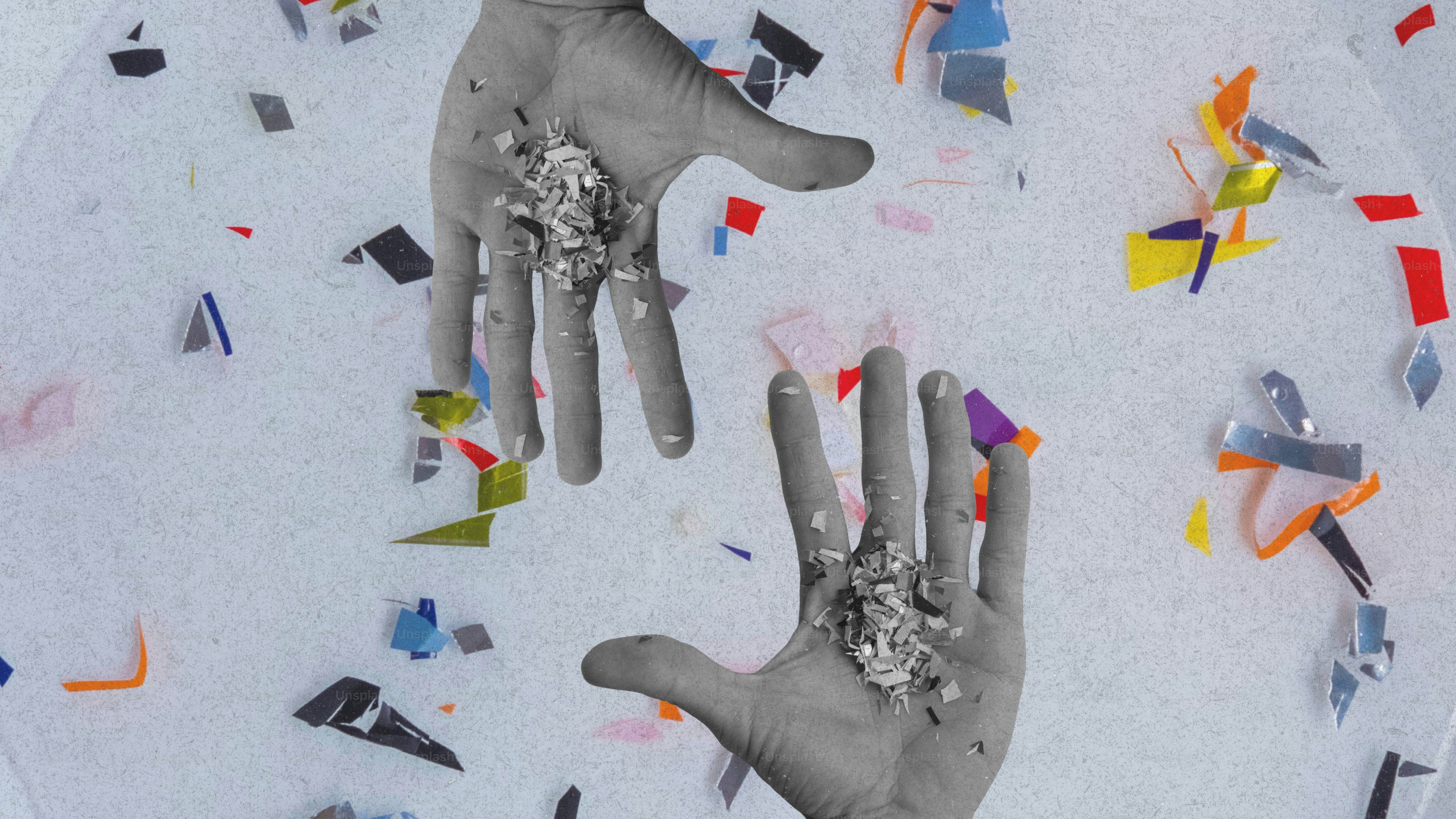 Hands reaching for scattered colorful confetti pieces