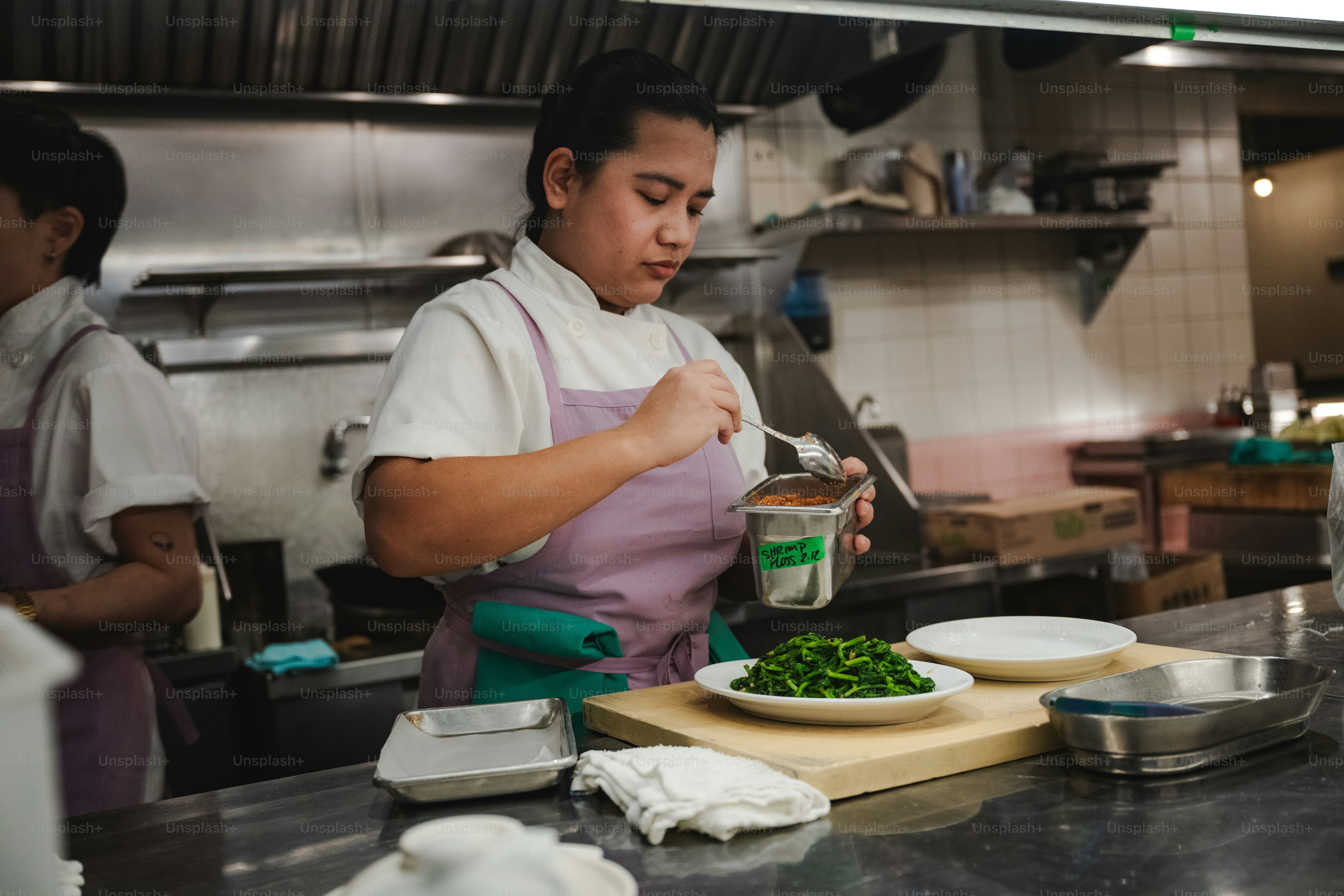 A chef prepares food in a professional kitchen.